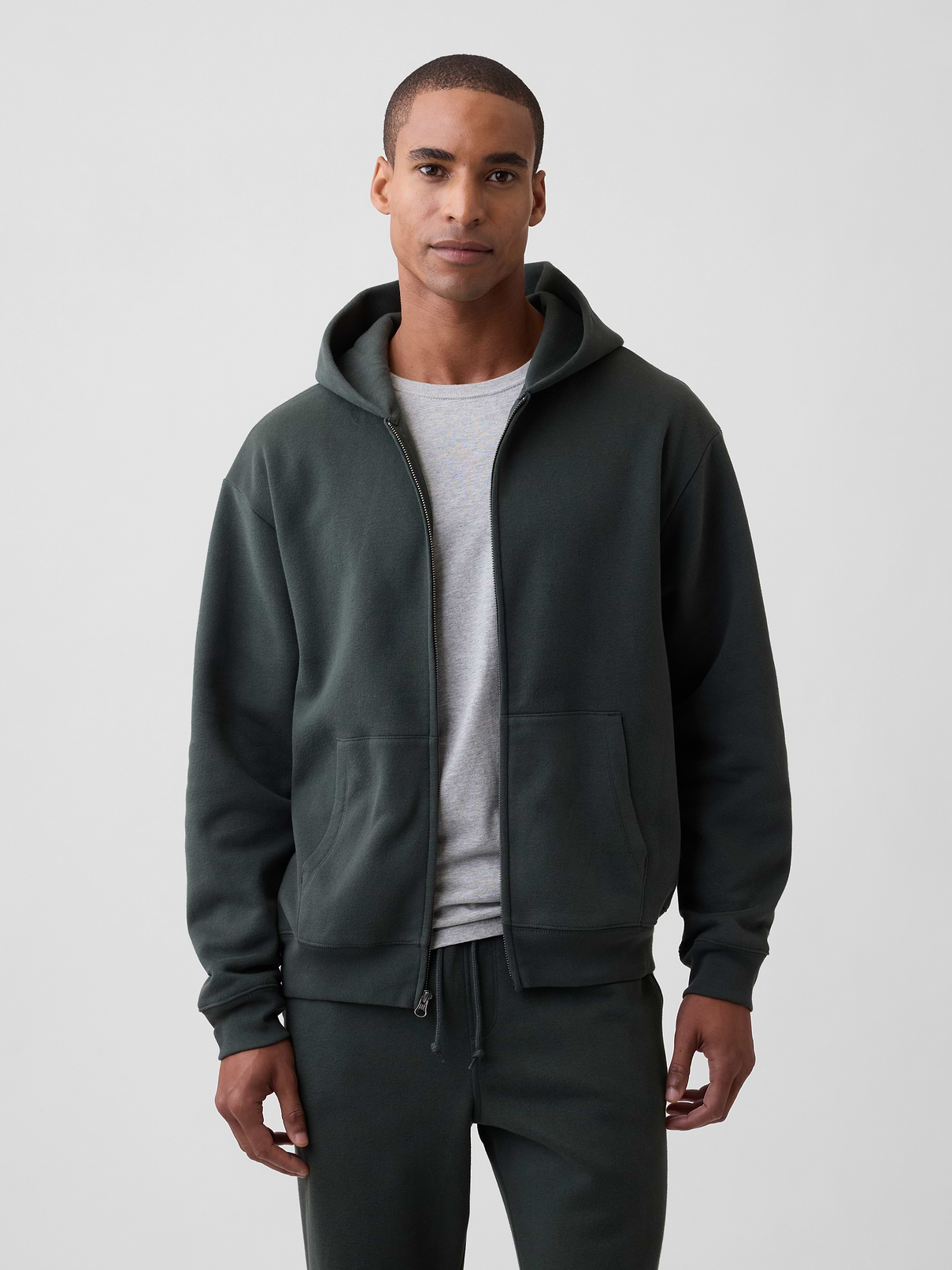 Image 1 of 4, This product is made with/contains 23% recycled polyester. Compared to virgin materials, using recycled materials helps reduce resource use and waste., Soft, comfy fleece., Dropped shoulder, long sleeves with banded cuffs., Drawcord ties at hood, zip front., Kanga pockets., Banded hem., This product was made in a factory that invests in gender equity and women’s empowerment through RISE. Learn more at, Product #819070