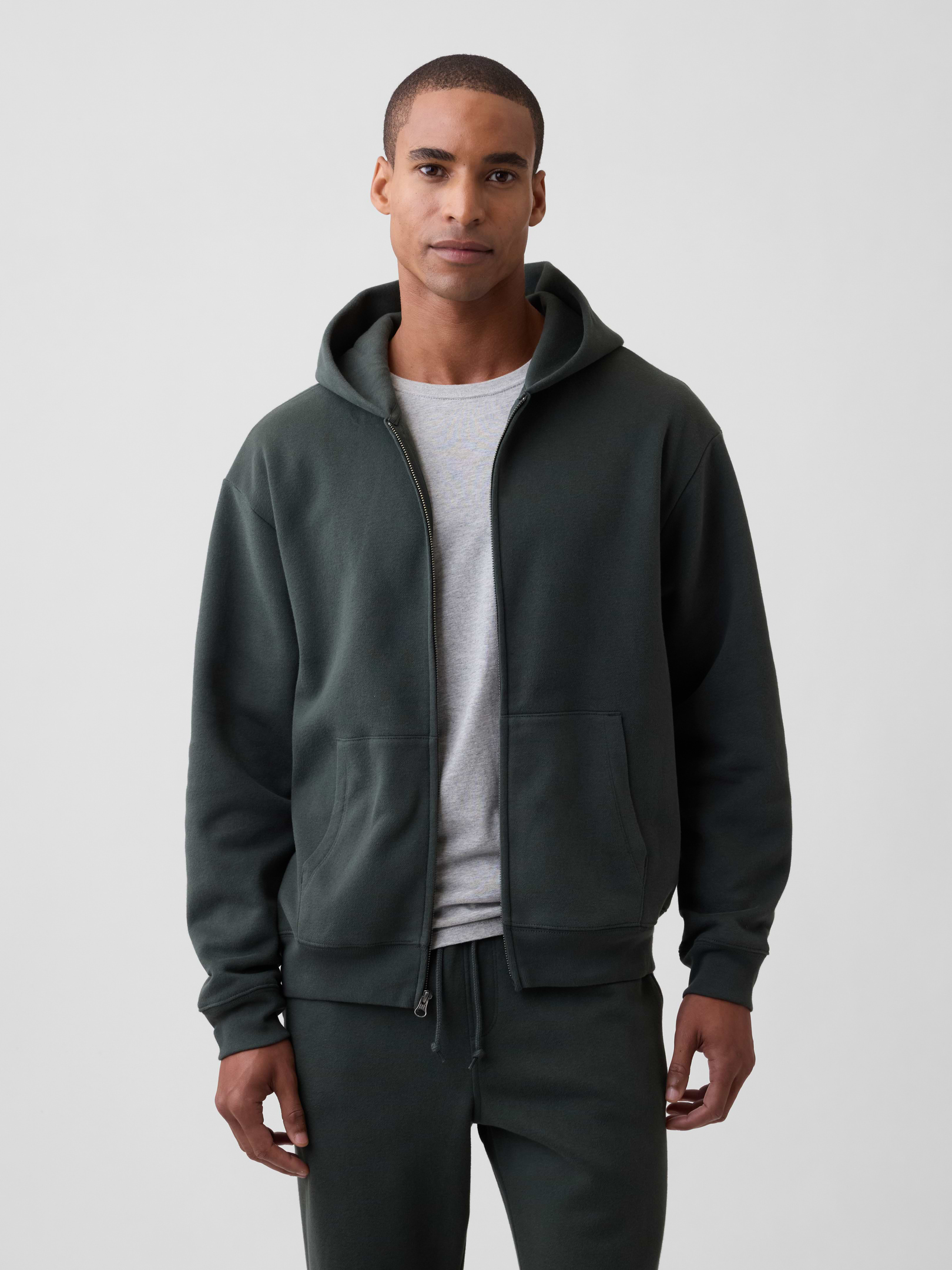 Image 1 of 4, This product is made with/contains 23% recycled polyester. Compared to virgin materials, using recycled materials helps reduce resource use and waste., Soft, comfy fleece., Dropped shoulder, long sleeves with banded cuffs., Drawcord ties at hood, zip front., Kanga pockets., Banded hem., This product was made in a factory that invests in gender equity and women’s empowerment through RISE. Learn more at, Product #819070