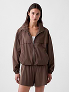 Image 1 of 5, Crinkle cotton-nylon poplin track jacket. In an oversized fit and slightly cropped length., Mockneck, zipper front., Long raglan sleeves with elasticized cuffs., Front welt pockets., Bungee hem., This product was made in a factory that invests in gender equity and women’s empowerment through RISE. Learn more at gapinc.com/equity ., Product #1186874