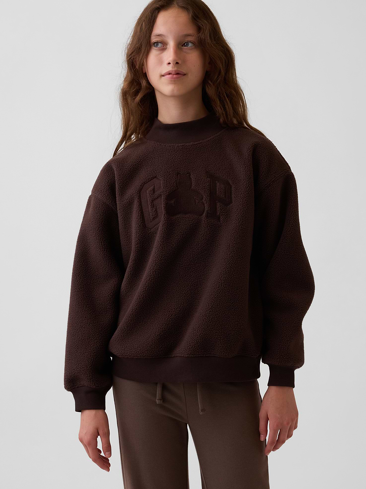 Image 1 of 6, Soft sherpa pullover sweatshirt. In an oversized fit and longer length., Mockneck., Long sleeves with drop shoulders., Gap logo with Brannan Bear graphic at front., Banded rib cuffs and hem., Made with 25% recycled polyester. Compared to virgin materials, using recycled materials helps reduce resource use and waste., This product was made in a factory that invests in gender equity and women’s empowerment through RISE. Learn more at gapinc.com/equity ., Product #1184758