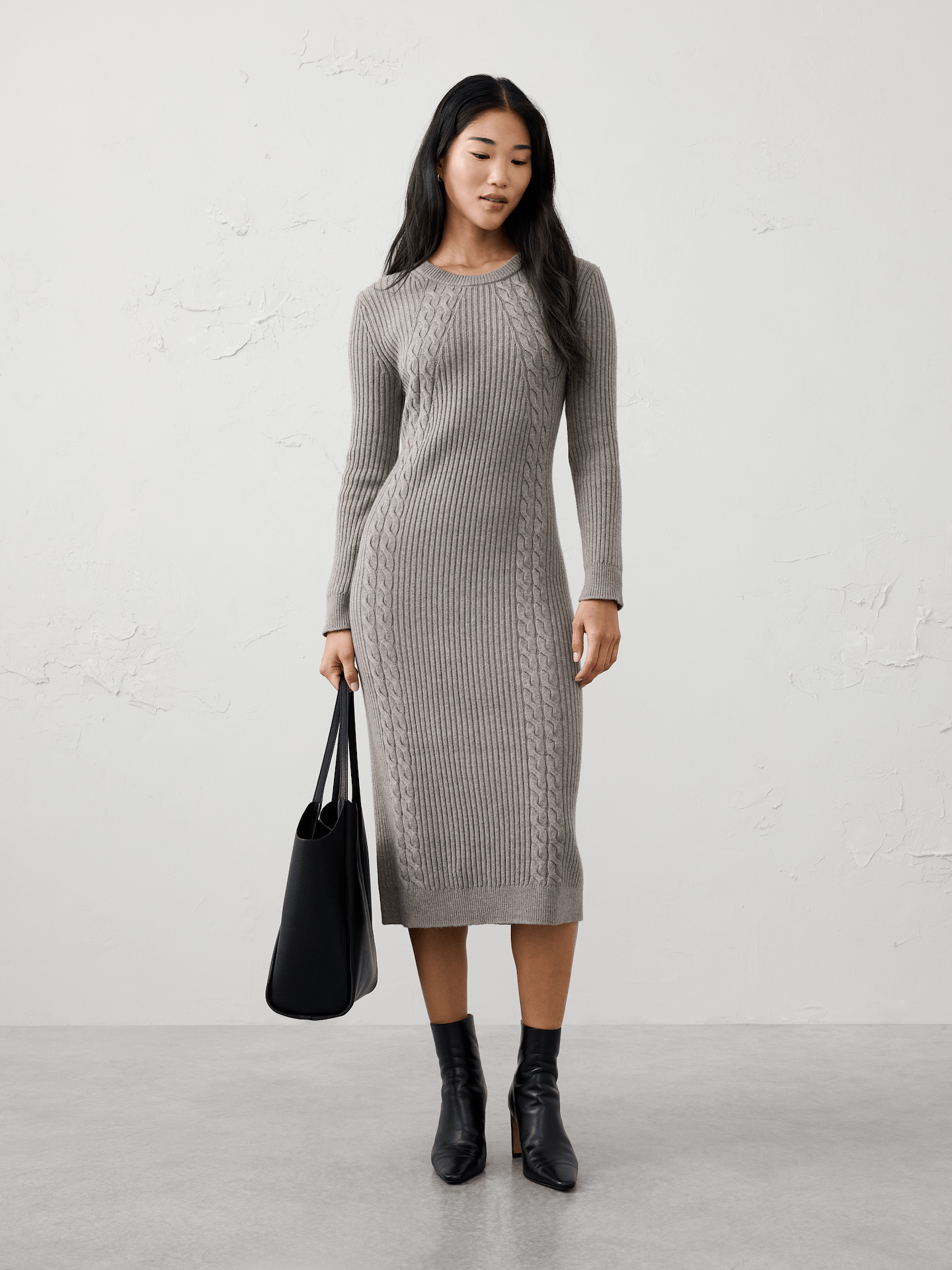 Image 1 of 5, A modern cable knit brings rich texture and cozy warmth to this effortlessly elevated midi dress. Designed with a flattering silhouette and timeless appeal, it offers the perfect balance of comfort and polish for cooler days., Crew neck. Long sleeves., Ribbed neck, arm cuffs and hem., Cable knit detailing., Made exclusively for Banana Republic Factory., Product #1176481