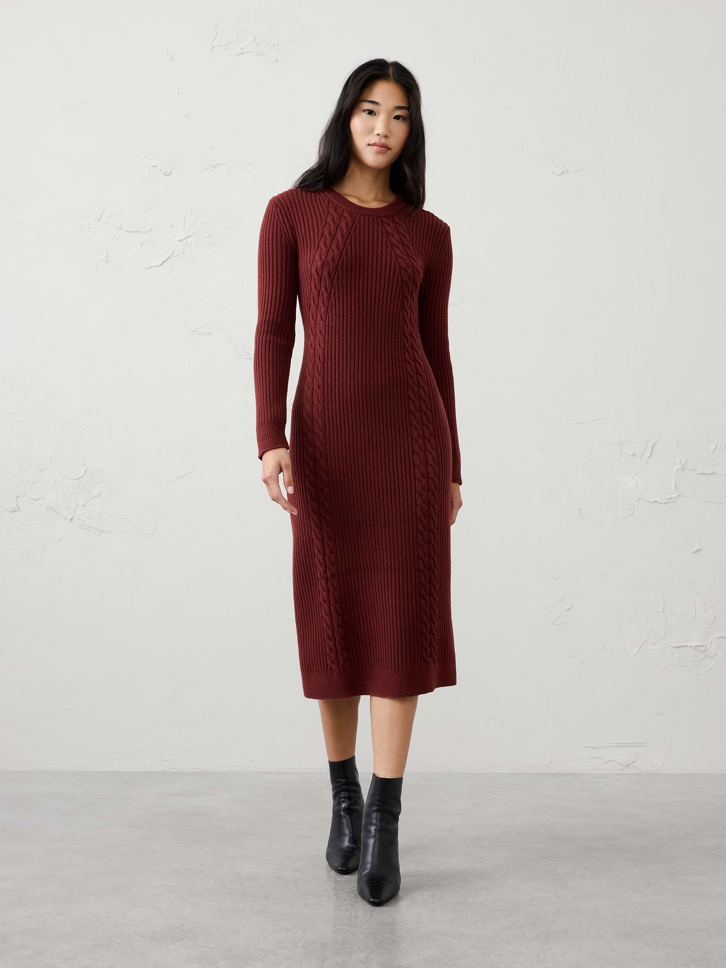 Image 1 of 5, A modern cable knit brings rich texture and cozy warmth to this effortlessly elevated midi dress. Designed with a flattering silhouette and timeless appeal, it offers the perfect balance of comfort and polish for cooler days., Crew neck. Long sleeves., Ribbed neck, arm cuffs and hem., Cable knit detailing., Made exclusively for Banana Republic Factory., Product #1176481