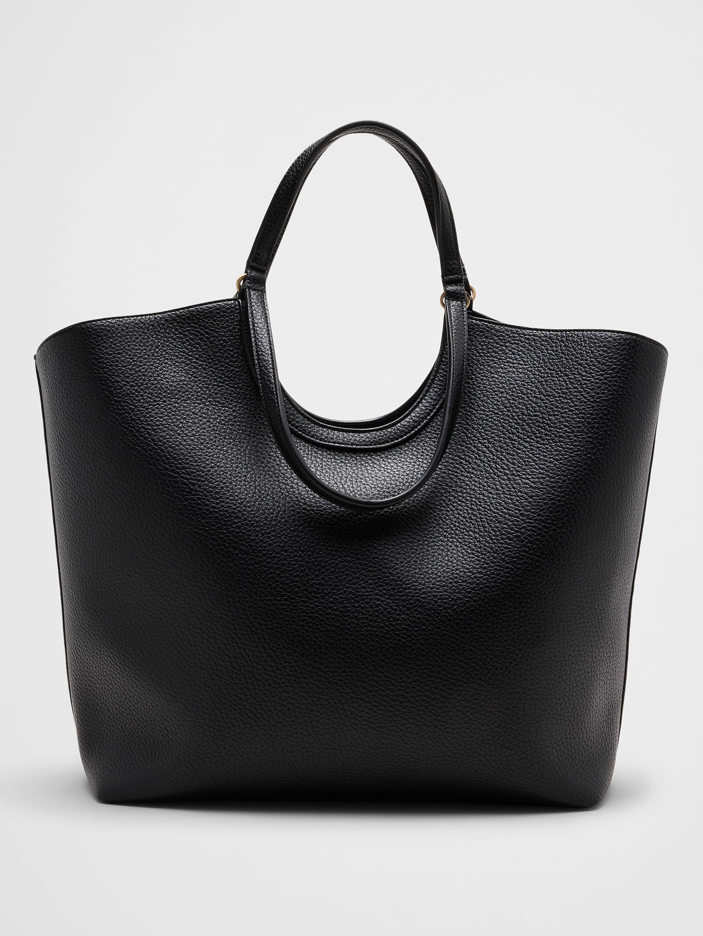 Image 1 of 5, Crafted in smooth vegan leather, this spacious tote is designed to carry everything you need from work to weekend. Featuring double handles and a roomy interior, it combines everyday functionality with a clean, polished look that complements any outfit., VEGAN LEATHER: Soft and smooth, this faux leather looks and feels luxurious., Made exclusively for Banana Republic Factory., Product #1180952