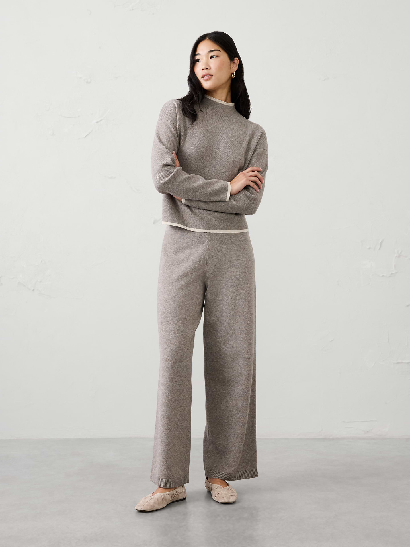 Image 1 of 4, Relaxed, comfortable, and effortlessly polished, this mid-rise sweater pant is crafted from a super-soft cotton-blend sweater yarn for an elevated take on everyday comfort. The easy pull-on design features a flowing straight-leg silhouette that moves with ease. Perfect for lounging or traveling, this versatile knit pant offers cozy style for wherever the day takes you., Pull-on pant., Ribbed elastic waistband., Relaxed silhouette., Made exclusively for Banana Republic Factory., Product #1179513