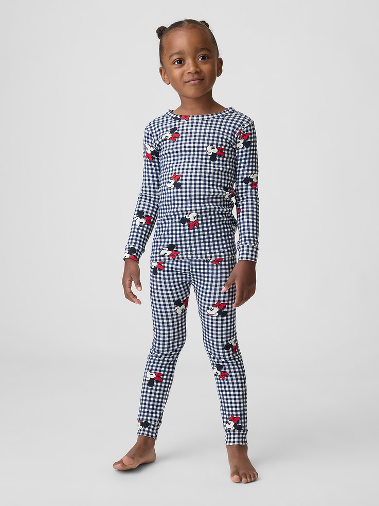 Image 1 of 5, A very special collaboration between Gap and Disney— two timeless, iconic American brands— led us to create a collection that celebrates Mickey Mouse and Minnie Mouse., Soft cotton knit., Long sleeves with banded cuffs., Crewneck., Elasticized waist., Banded cuffs., Allover gingham and Minnie Mouse print., Shop matching PJs for all., This product was made in a factory that invests in gender equity and women’s empowerment through RISE. Learn more at, Product #1185561