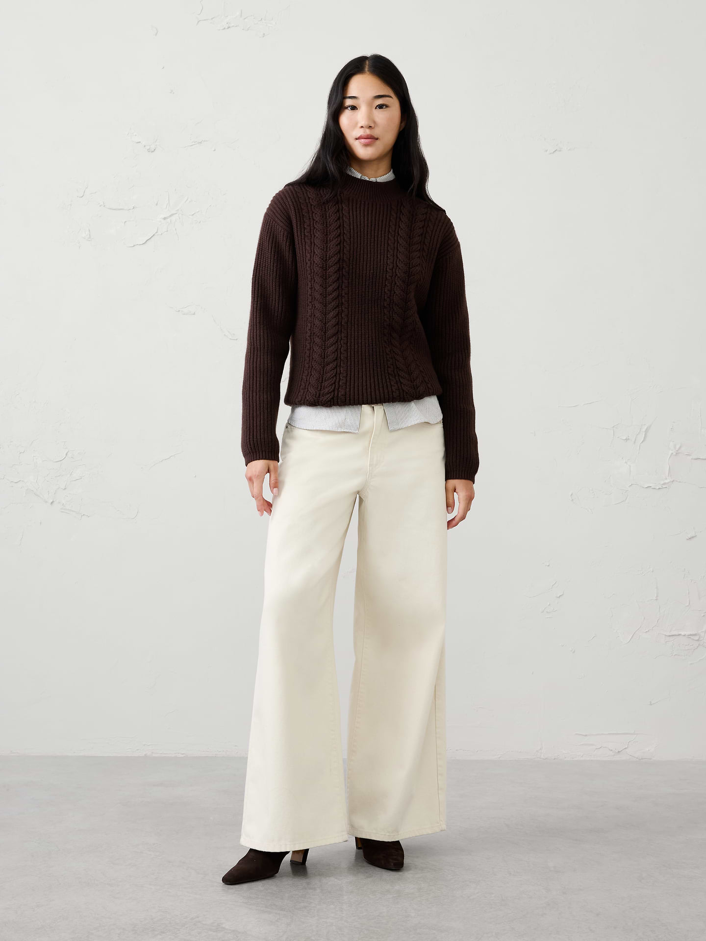 Image 1 of 4, Our sweater is knit from our signature Perfectly Soft yarn—a luxurious blend of cotton with a hint of wool, that feels as cozy as it looks. Classic cable stitching adds timeless texture and dimension, elevating the silhouette with a heritage‑inspired touch., Mock neck. Long sleeves., Drop shoulders., Made exclusively for Banana Republic Factory., Product #1177060