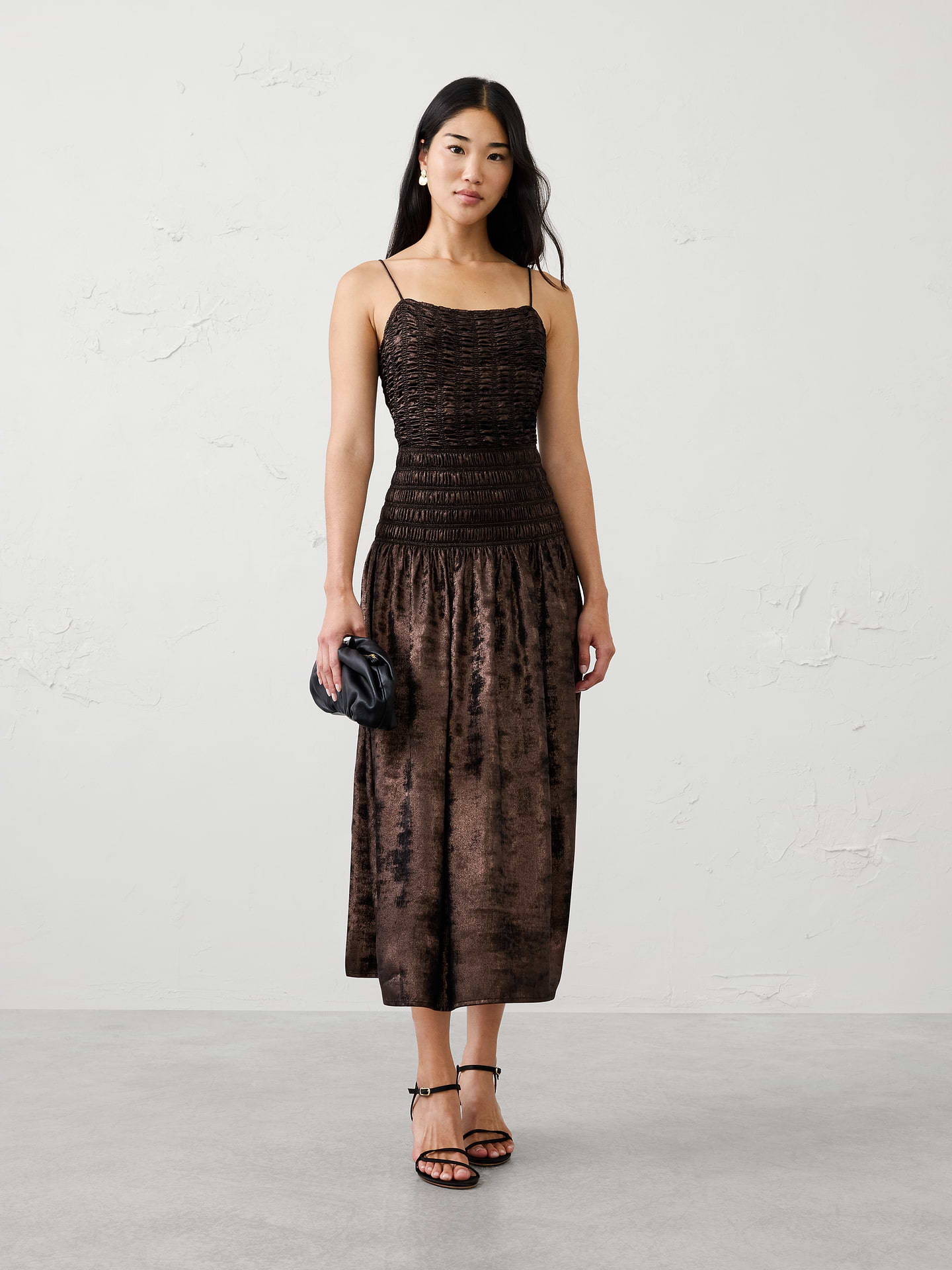 Image 1 of 1, Our customer‑favorite smocked silhouette gets a glamorous update in shimmering metallic lamé for an elevated take on occasion dressing., Adjustable spaghetti straps., Smocked bodice., Elasticated waist., Softly gathered skirt., Made exclusively for Banana Republic Factory., Product #1185684