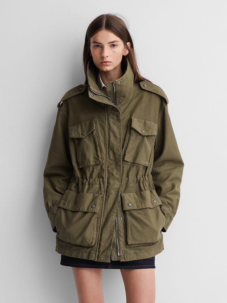 Image 1 of 7, Soft cotton utility jacket. In an oversized fit., Mockneck with snap button closure., Long sleeves with button cuffs and shoulder epaulettes., Hidden zipper under snap button closure., Cinched waist with bungee cord., Snap-button flap patch pockets at front., Made with 30% recycled cotton. Compared to virgin materials, using recycled materials helps reduce resource use and waste., Product #1179764