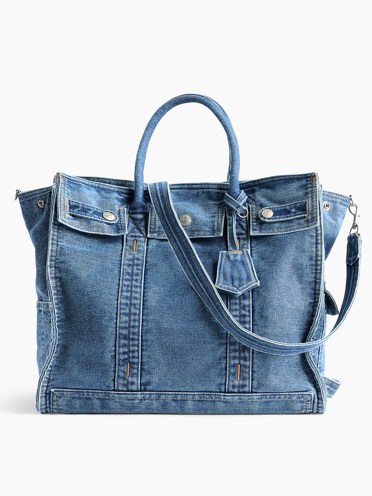 Image 1 of 2, Soft cotton denim tote bag., Worn at the elbow, over the shoulder, or handheld., Double handles and removable shoulder strap., Bridge snap closure at top., Button-snap pocket at front., Two outer side slip pockets., Key-holder tag at handle., Two interior slip pockets., Laptop friendly: up to 15"., Responsibly Made: This bag is part of our water-saving Washwell program. Compared with conventional wash methods, Washwell uses at least 20% less water., Note: The dye used in the crafting of this product is prone to crocking, or color transfer. Please avoid contact with light-colored fabric or upholstery., Explore our GapBag Collection ., Product #1181518