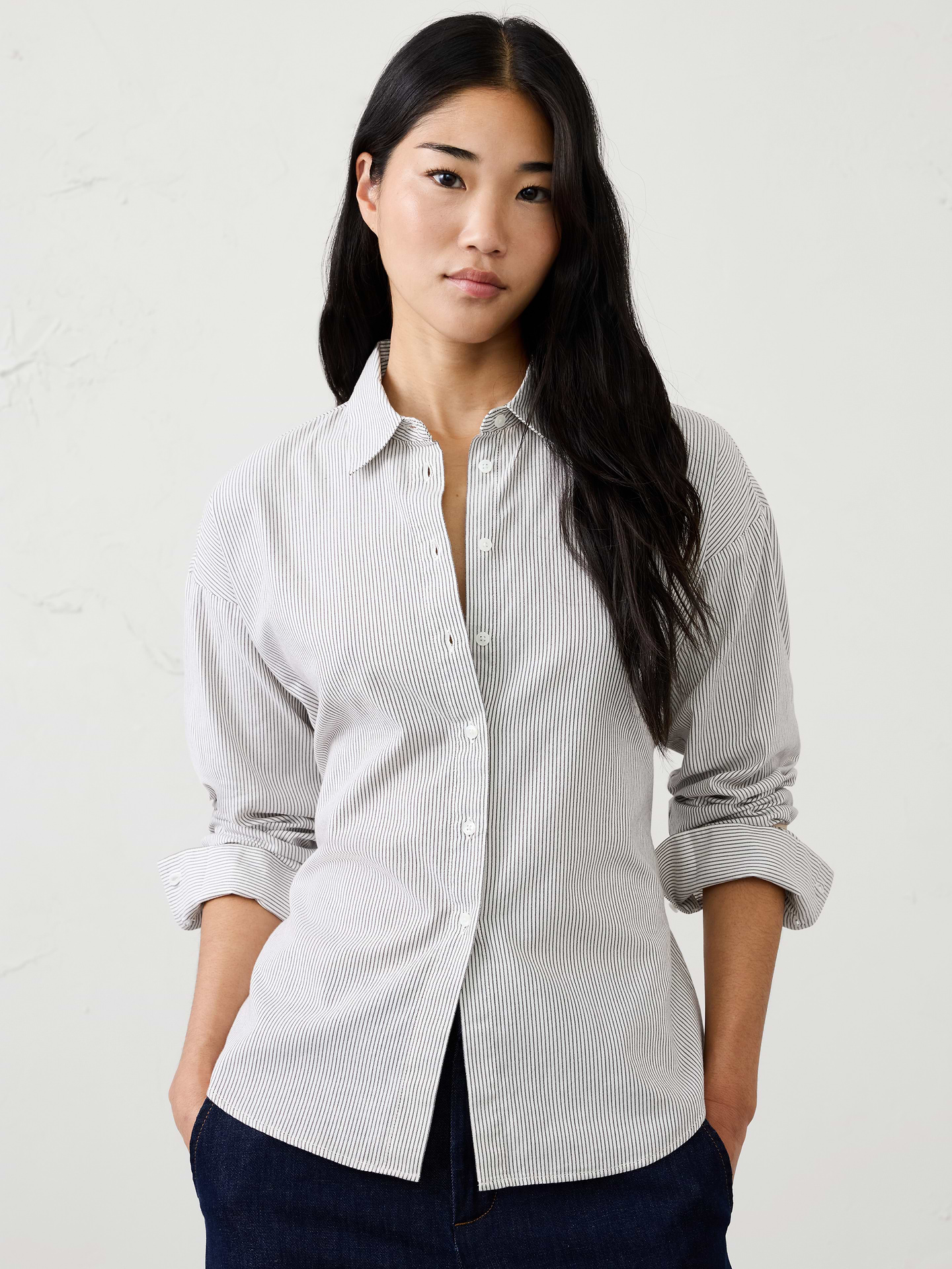 Image 1 of 4, Made from a warm‑handed oxford fabric, this shirt combines classic styling with a modern tie‑back detail. Comfortable and versatile, it's an easy piece for casual winter dressing with a feminine, flattering finish., Pointed collar. Long sleeves with extended cuffs and button closures., Drop shoulders., Button-front closure., Self‑tie detail at the back allows for adjustable shaping., Shirttail hem., Made exclusively for Banana Republic Factory., Product #1185904