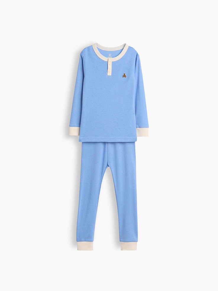 Image 1 of 2, Our comfiest PJs—now softer than ever. Cozy brushed cotton on the inside. All their favorite prints & colors on the outside., Soft organic cotton Henley pajama top and PJ pants set with a cozy brushed interior., Crewneck with front button placket., Long sleeves., Embroidered Brannan Bear at chest., Elasticized waist at PJ pants., Banded cuffs., Colorblock design., Made with 100% organically grown cotton which is grown without the use of synthetic pesticides and fertilizers., This product was made in a factory that invests in gender equity and women’s empowerment through RISE. Learn more at gapinc.com/equity ., Product #1186423
