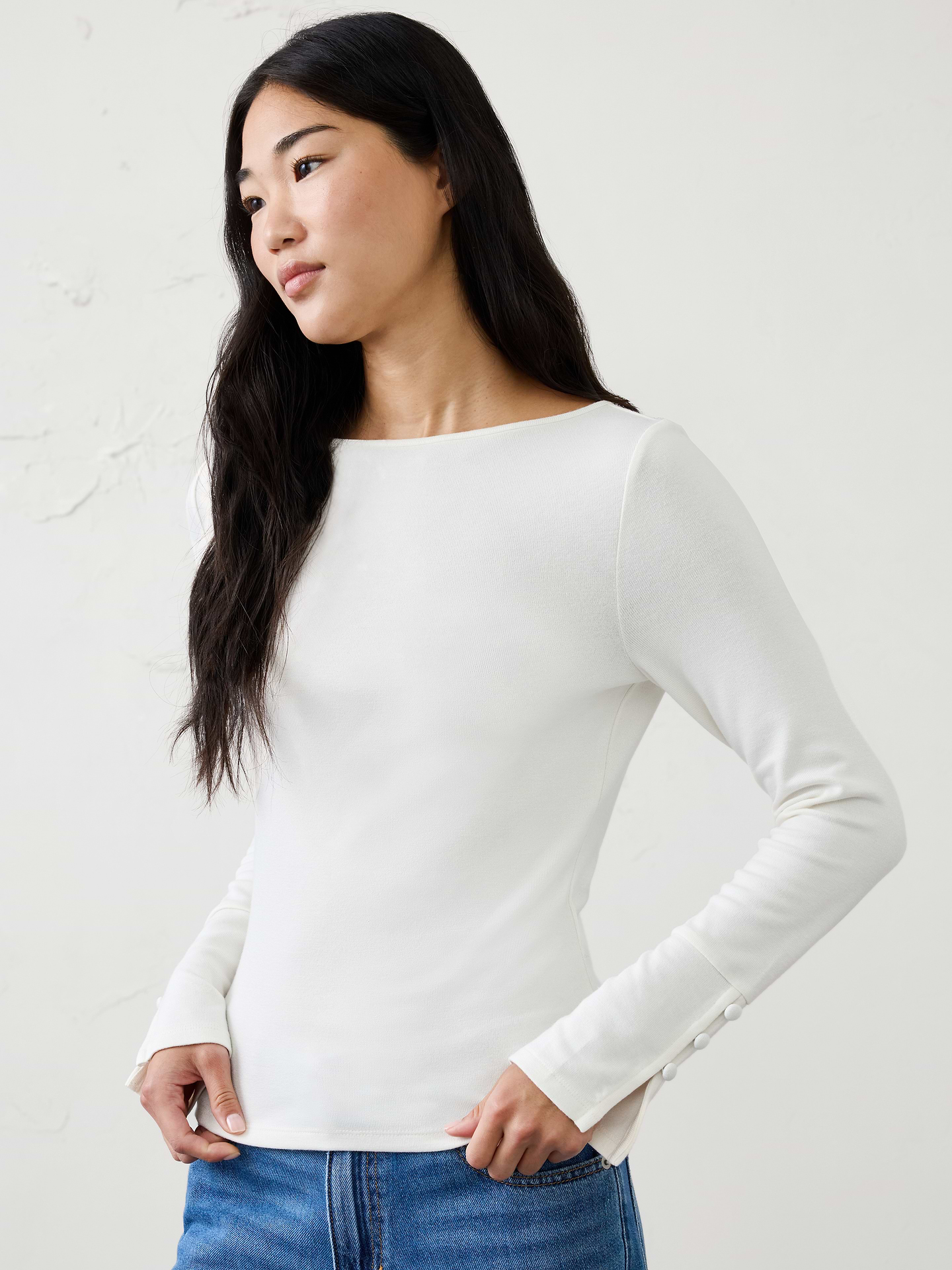Image 1 of 4, A customer favorite, our Soft Luxe knit returns as a cozy yet lightweight alternative to a traditional sweater. It offers versatile comfort that layers beautifully and transitions effortlessly through the season., Boat neckline. Long sleeves., Decorative button detail accents the lower sleeves., Fitted at the waist., Made exclusively for Banana Republic Factory., Product #1186025