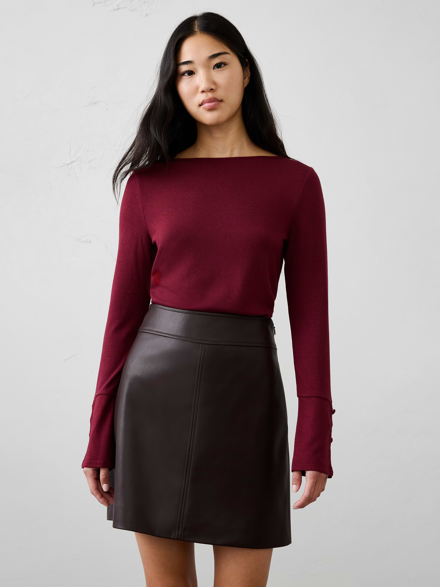 Image 1 of 4, A customer favorite, our Soft Luxe knit returns as a cozy yet lightweight alternative to a traditional sweater. It offers versatile comfort that layers beautifully and transitions effortlessly through the season., Boat neckline. Long sleeves., Decorative button detail accents the lower sleeves., Fitted at the waist., Made exclusively for Banana Republic Factory., Product #1186025