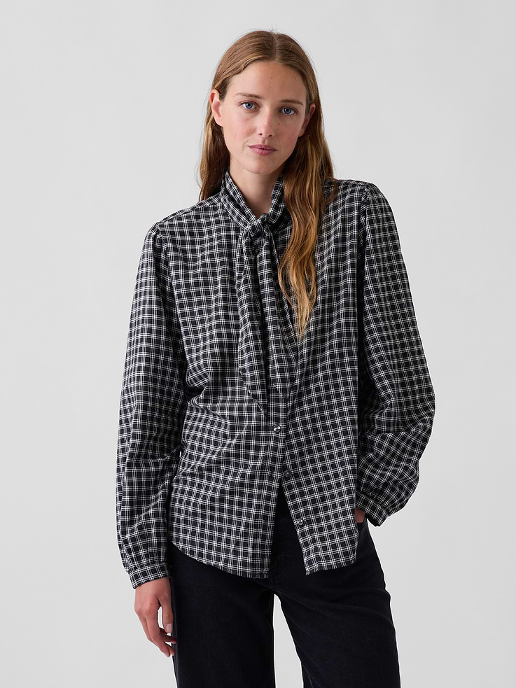 Image 1 of 5, Soft, lightweight stretch cotton twill button-up shirt., Tie neck with band collar., Long sleeves with button cuffs., Button front., Shirttail hem., Allover plaid., This product was made in a factory that invests in gender equity and women’s empowerment through RISE. Learn more at gapinc.com/equity ., Product #1184321