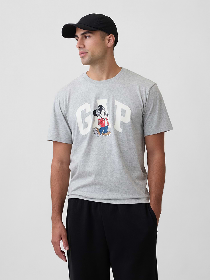 Image 1 of 5, A very special collaboration between Gap and Disney— two timeless, iconic American brands— led us to create a collection that celebrates Mickey Mouse and Minnie Mouse., Soft jersey knit., Dropped shoulder, short sleeves., Crewneck., Gap logo with graphic at front., Product #1180090