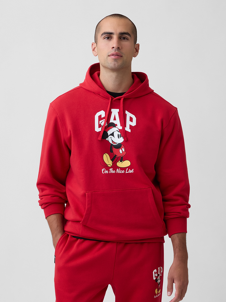 Image 1 of 4, A very special collaboration between Gap and Disney— two timeless, iconic American brands— led us to create a collection that celebrates Mickey Mouse and Minnie Mouse., This product is made with/contains 23% recycled polyester. Compared to virgin materials, using recycled materials helps reduce resource use and waste., Soft, comfy fleece., Dropped shoulder, long sleeves with banded cuffs., Drawcord ties at hood., Gap logo with graphic at front., Kanga pocket., Banded hem., Product #1187819