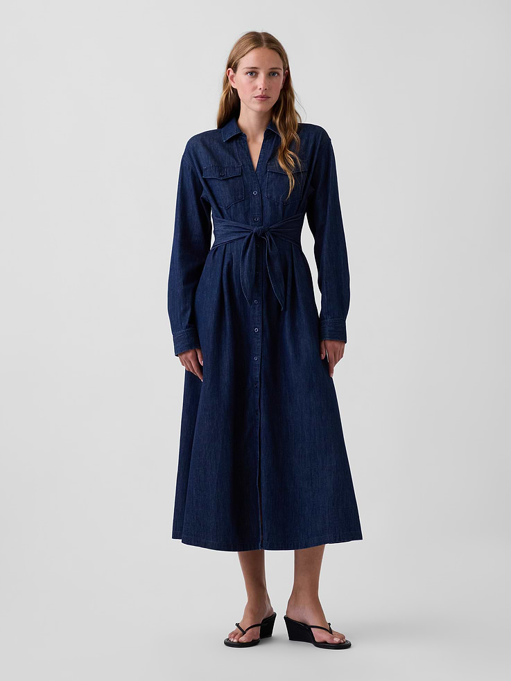 Image 1 of 5, Authentic, non-stretch denim maxi shirtdress., Spread collar, button front., Long sleeves with button cuffs., Button-flap patch pockets at chest., Back yoke seam and waist darts., Self tie detail at waist., Dark wash., Responsibly Made: This denim dress is part of our water-saving Washwell program. Compared with conventional wash methods, Washwell uses at least 20% less water., Made with 55% Protocol cotton verified by the U.S. Cotton Trust Protocol, a program which works with farms committed to improving their environmental footprint by minimizing water usage and improving soil health (Claim No. 10127)., This product was made in a factory that invests in gender equity and women’s empowerment through RISE. Learn more at gapinc.com/equity ., Product #1185328