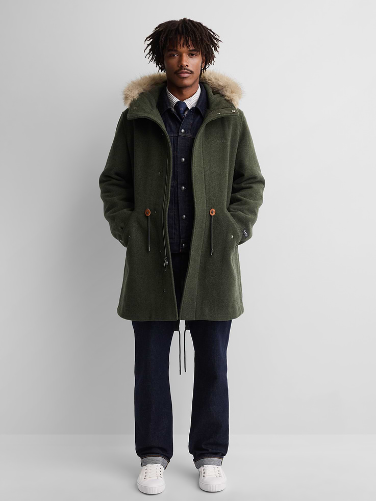 Image 1 of 10, Soft wool-blend parka jacket. In an oversized fit., Hooded neckline with vegan fur trim., Long sleeves., Hidden 2-way zipper under snap button closure., Embroidered Gap x A.P.C. logo at chest., Flap patch pockets at waist., Drawcords at waist and hem., Made with 50% recycled wool and 50% recycled polyester. Compared to virgin materials, using recycled materials helps reduce resource use and waste., Product #1179795