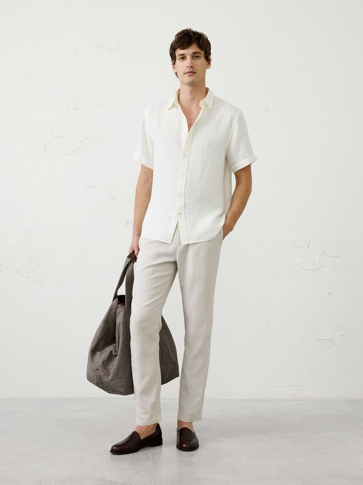Image 1 of 3, A short‑sleeve version of our herringbone linen-blend shirt, combining breathable comfort with subtle woven texture. Lightweight and easy to wear, it offers a polished yet relaxed look for warm days., Point collar. Short sleeves., Button‑front closure., Back yoke., Shirttail hem., Made exclusively for Banana Republic Factory., Product #1175902