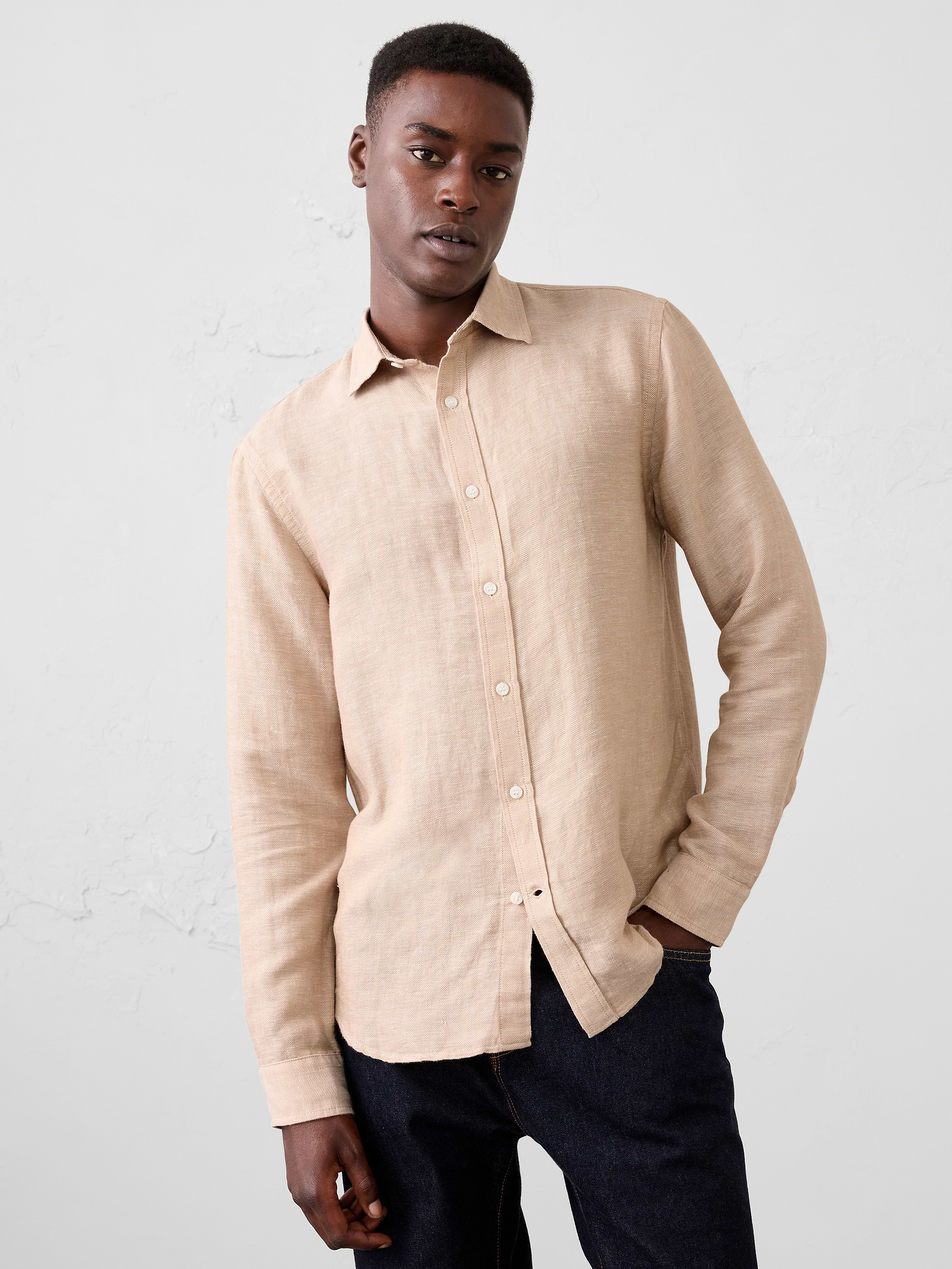 Image 1 of 7, Crafted from breathable linen-cotton blend, this shirt is elevated with a subtle herringbone weave that adds depth and texture. Designed in versatile colors, it delivers effortless warm‑weather style with a refined finish., Point collar. Long sleeves with adjustable double-button barrel cuffs and button vents., Button‑front closure., Back yoke., Shirttail hem., Made exclusively for Banana Republic Factory., Product #1175889