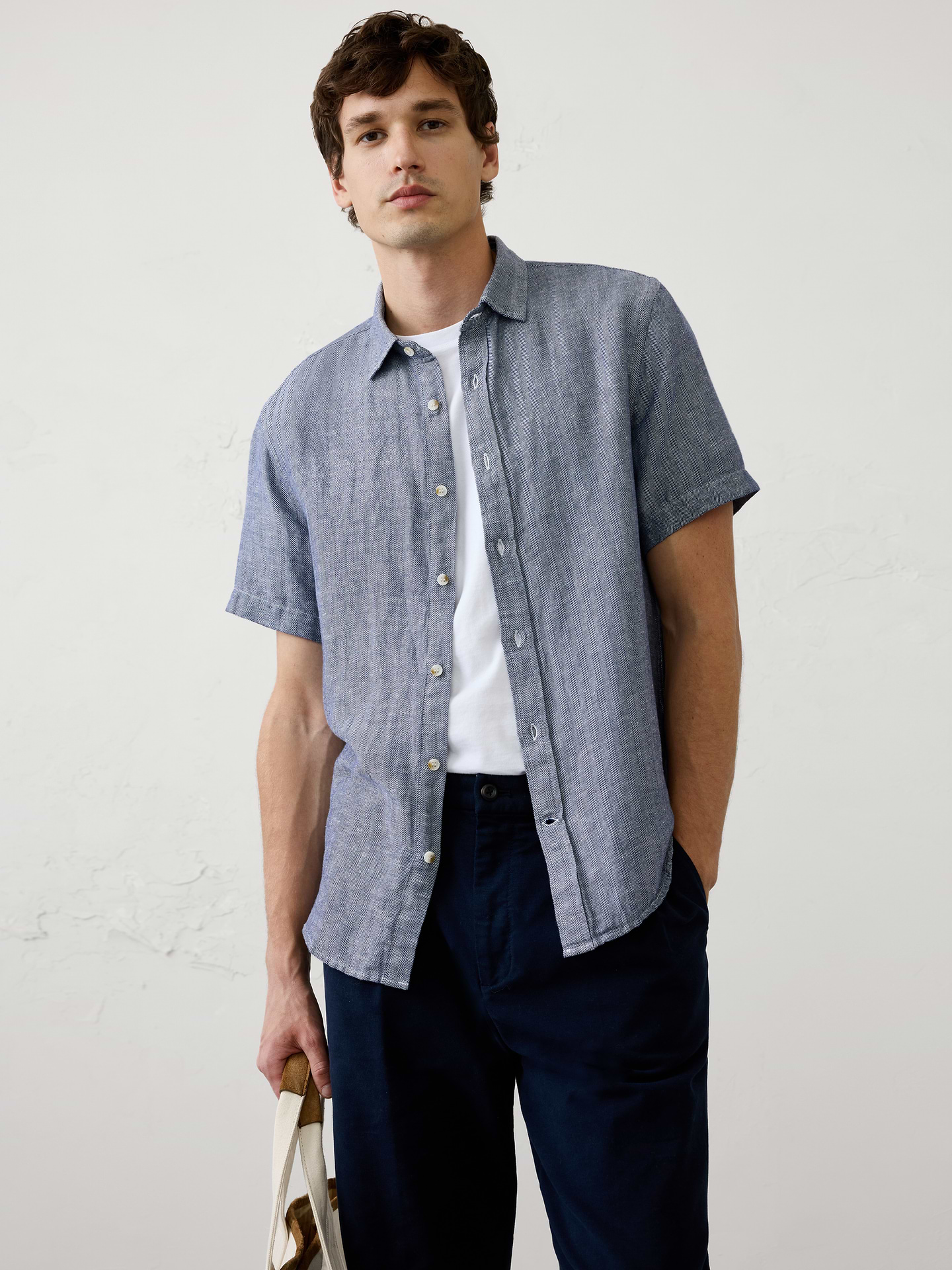 Image 1 of 3, A short‑sleeve version of our herringbone linen-blend shirt, combining breathable comfort with subtle woven texture. Lightweight and easy to wear, it offers a polished yet relaxed look for warm days., Point collar. Short sleeves., Button‑front closure., Back yoke., Shirttail hem., Made exclusively for Banana Republic Factory., Product #1175902
