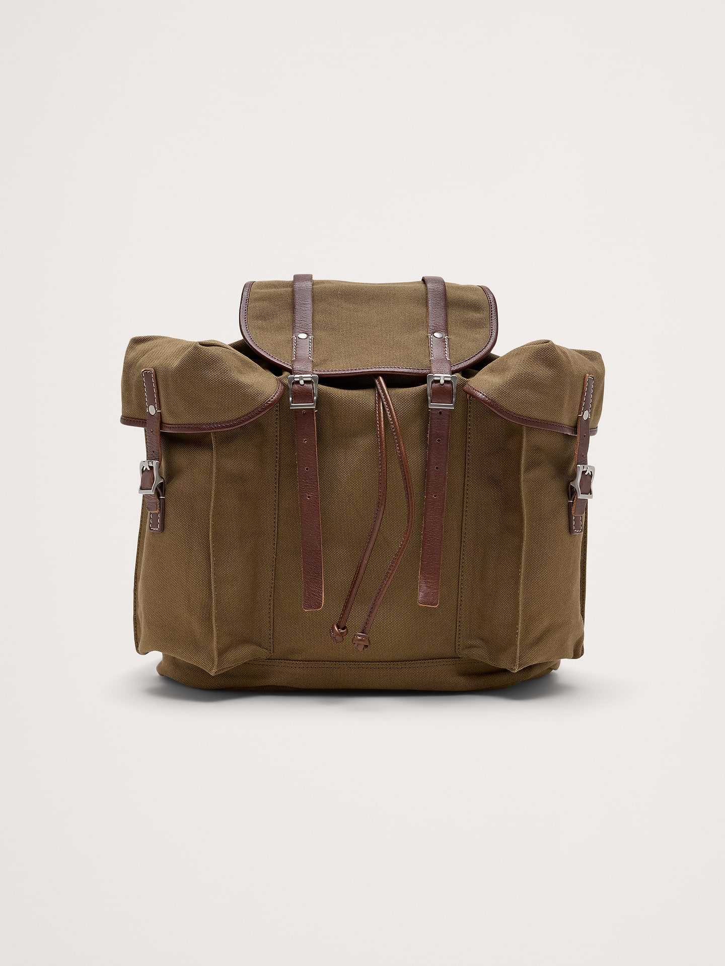 Image 1 of 1, Made from sturdy cotton canvas and leather, this traditional rucksack has a plethora of pockets to keep things organized on all your adventures. In short, an old-fashioned companion for a dedicated wanderer., Drawstring and buckled closure., Internal and external pockets., Adjustable shoulder straps., Fully lined., Product #1190377