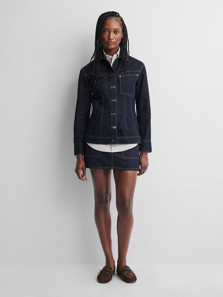 Image 1 of 10, Authentic, rigid denim mini skirt., Logo button closure, zip fly., Slanted patch pockets, back welt pockets., Gap × A.P.C. logo leather patch at back., Responsibly Made: This skirt is part of our water-saving Washwell program. Compared with conventional wash methods, Washwell uses at least 20% less water., More Sustainable Cotton: Made with 100% regeneratively grown cotton which is grown using holistic agricultural practices that aim to improve soil health and water retention., Product #1179766