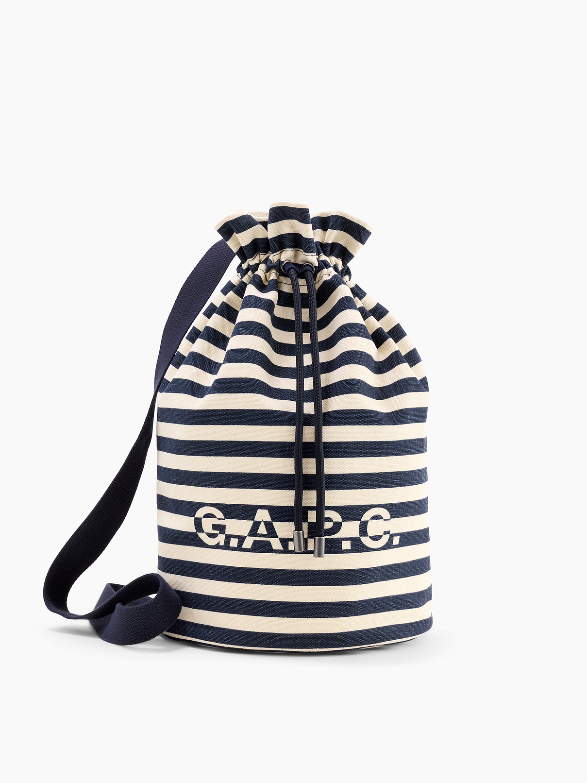 Image 1 of 5, Sturdy cotton canvas bucket bag., Adjustable shoulder strap., Drawstring closure at top., Gap × A.P.C. logo at front., Allover stripes., Product #1179740