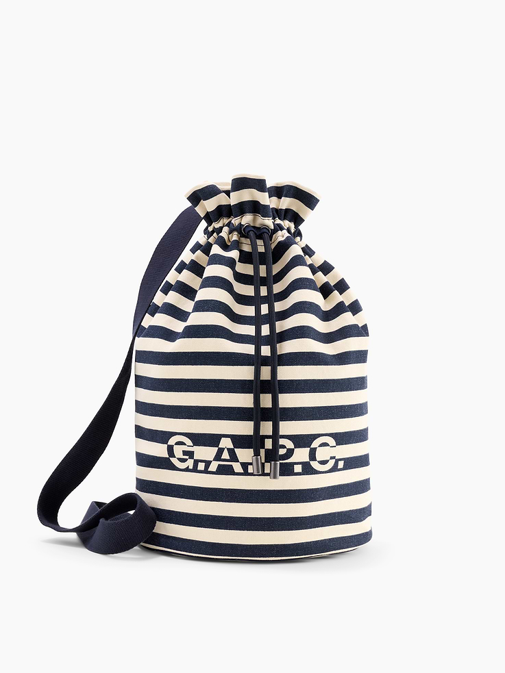 Image 1 of 5, Sturdy cotton canvas bucket bag., Adjustable shoulder strap., Drawstring closure at top., Gap × A.P.C. logo at front., Allover stripes., Product #1179740