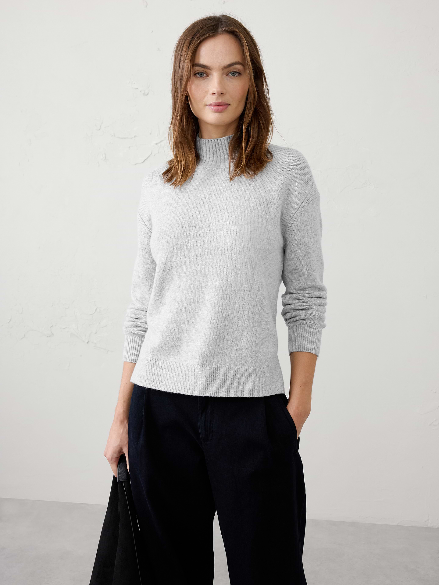 Image 1 of 3, Designed to be a go‑to layering essential, this sweater offers a soft, warm hand feel with lightweight comfort that never feels bulky. Cozy and versatile, it's perfect for transitional weather, whether worn on its own or layered under jackets and outerwear. Effortlessly polished and easy to style, it's a piece you'll reach for season after season., Mock neckline. Long sleeves., Drop shoulders., Ribbed neckline, arm cuffs and hem., Side seam slits at hem., Made exclusively for Banana Republic Factory., Product #1177078