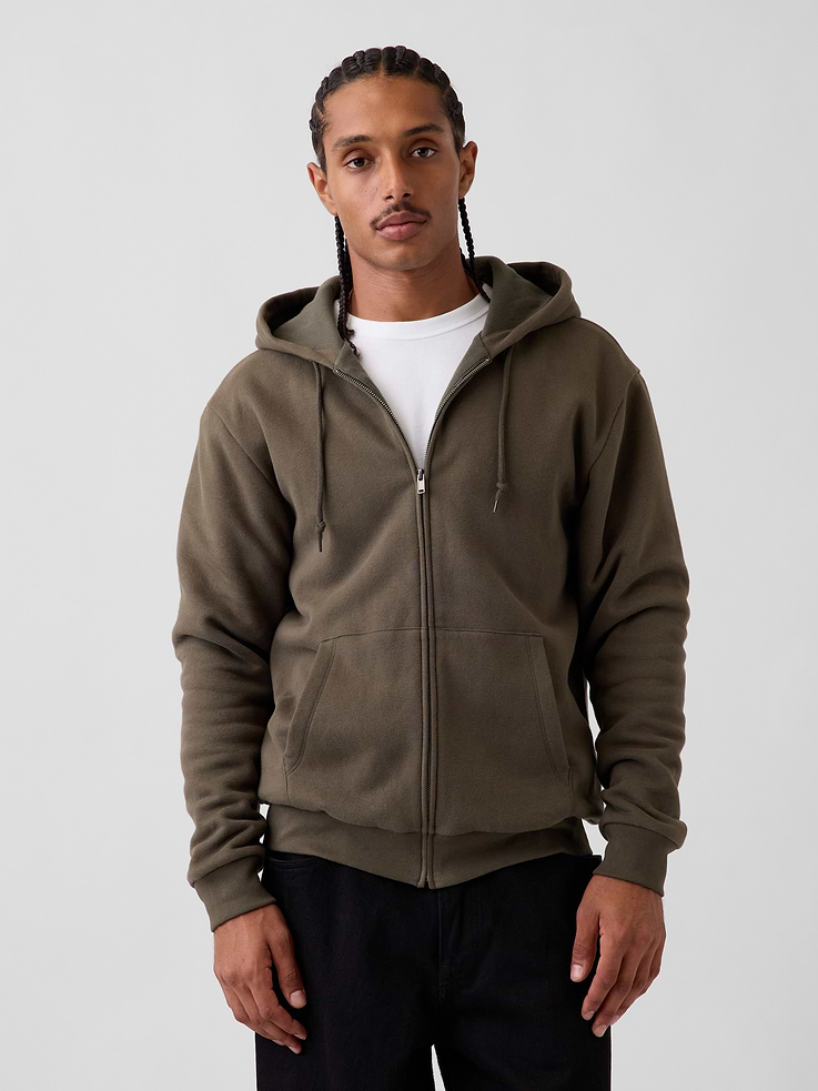 Image 1 of 5, Soft cotton-blend fleece zip hoodie with a waffle-knit lining. In a relaxed fit., Hooded neckline with drawcords., Long sleeves with drop shoulders., Zipper front., Kanga pockets., Banded rib cuffs and hem., Fleece outer made with 52% Protocol cotton verified by the U.S. Cotton Trust Protocol, a program which works with farms committed to improving their environmental footprint by minimizing water usage and improving soil health (Claim No. 10127)., Fleece outer made with 23% recycled polyester. Compared to virgin materials, using recycled materials helps reduce resource use and waste., This product was made in a factory that invests in gender equity and women’s empowerment through RISE. Learn more at gapinc.com/equity ., Product #1184630