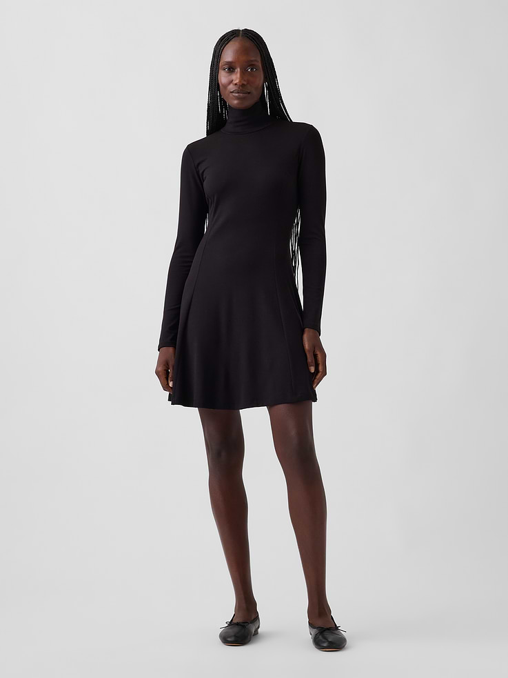 Image 1 of 5, Soft, stretch knit rayon mini dress., Mockneck., Long sleeves., Vertical seaming at front and back., This product was made in a factory that invests in gender equity and women’s empowerment through RISE. Learn more at gapinc.com/equity ., Product #1185327