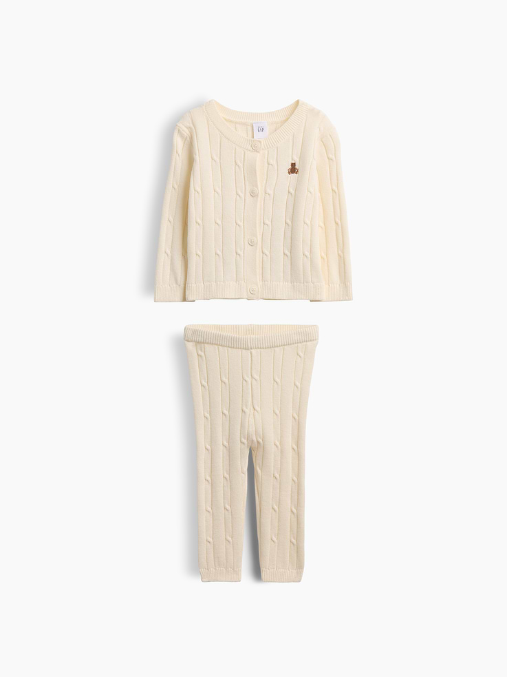 Image 1 of 3, Soft cable-knit cotton cardigan sweater and pull-on sweater pants outfit set., Crewneck, button front., Long sleeves., Embroidered Brannan Bear at chest., Elasticized waist at pants., Ribbed cuffs and hem., This product was made in a factory that invests in gender equity and women’s empowerment through RISE. Learn more at gapinc.com/equity ., Product #1185430