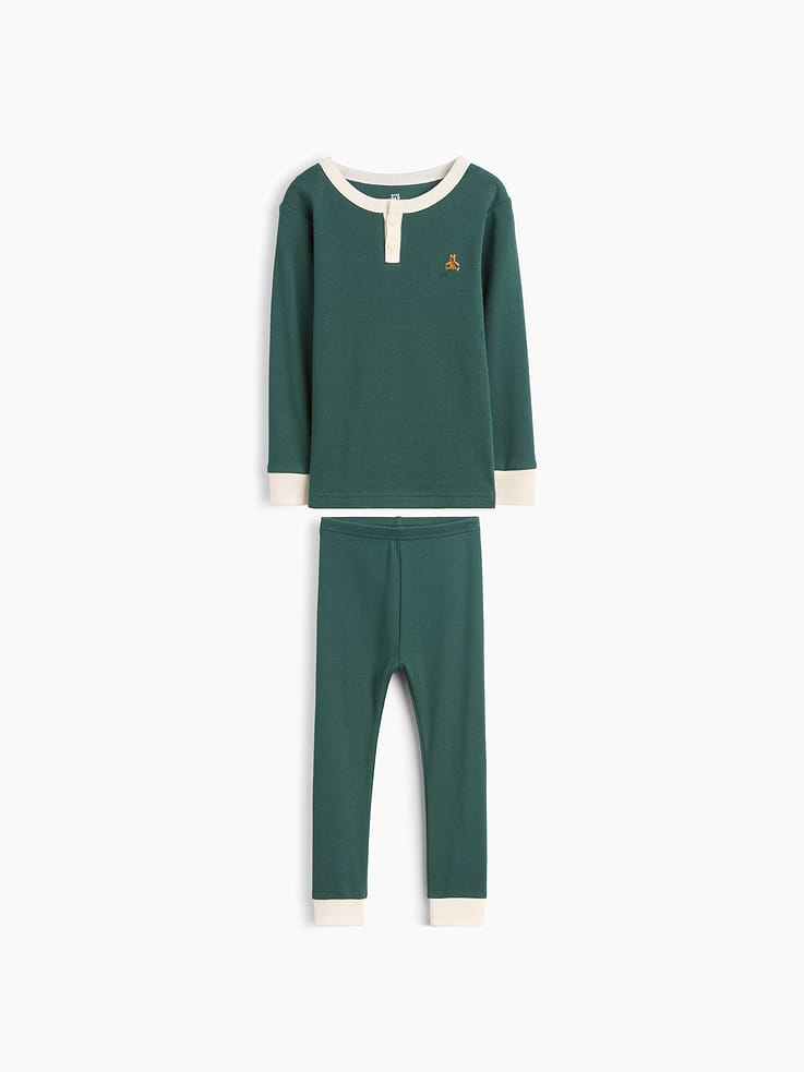 Image 1 of 2, Our comfiest PJs—now softer than ever. Cozy brushed cotton on the inside. All their favorite prints & colors on the outside., Soft organic cotton Henley pajama top and PJ pants set with a cozy brushed interior., Crewneck with front button placket., Long sleeves., Embroidered Brannan Bear at chest., Elasticized waist at PJ pants., Banded cuffs., Colorblock design., Made with 100% organically grown cotton which is grown without the use of synthetic pesticides and fertilizers., This product was made in a factory that invests in gender equity and women’s empowerment through RISE. Learn more at gapinc.com/equity ., Product #1186423