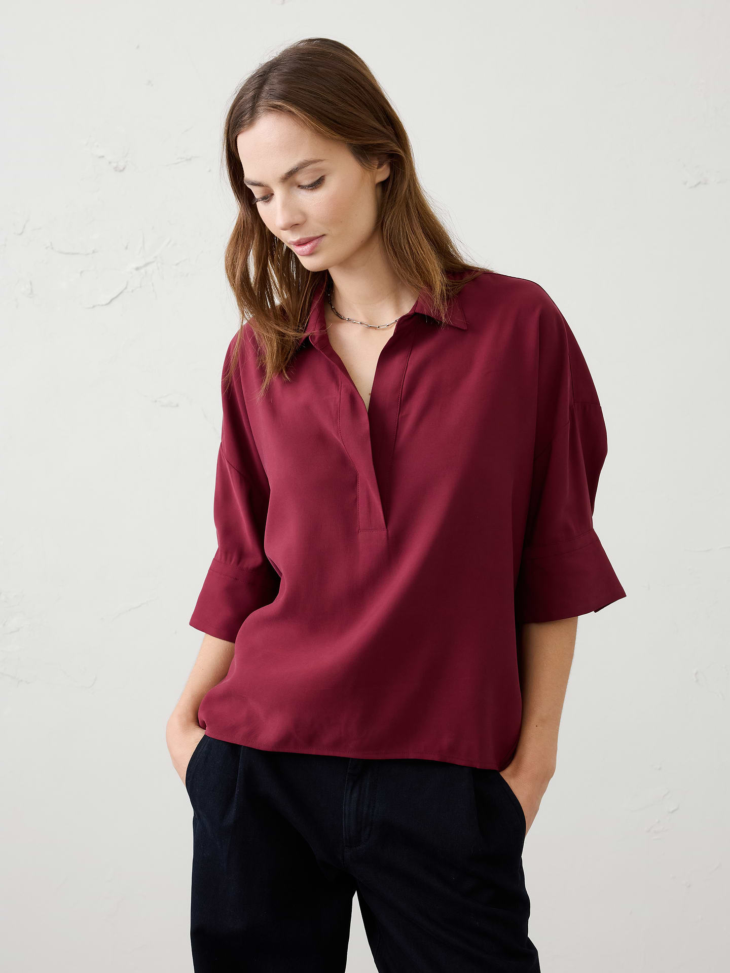 Image 1 of 7, Our classic popover silhouette, crafted in soft, drapey twill for an effortless feel and elevated finish., Point collar with split V‑neckline and an elongated placket. Wide elbow-length sleeves with folded cuff detail., Drop shoulders., Back yoke seam., High-low shirttail hem., Made exclusively for Banana Republic Factory., Product #1178179