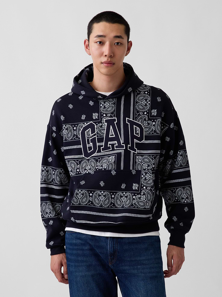 Image 1 of 8, Soft cotton-blend fleece pullover hoodie., Hooded neckline., Long sleeves with drop shoulders., Gap logo at front., Kanga pocket., Bandana print., Banded rib cuffs and hem., Made with 52% Protocol cotton verified by the U.S. Cotton Trust Protocol, a program which works with farms committed to improving their environmental footprint by minimizing water usage and improving soil health (Claim No. 10127)., Made with 23% recycled polyester. Compared to virgin materials, using recycled materials helps reduce resource use and waste., Product #1189003