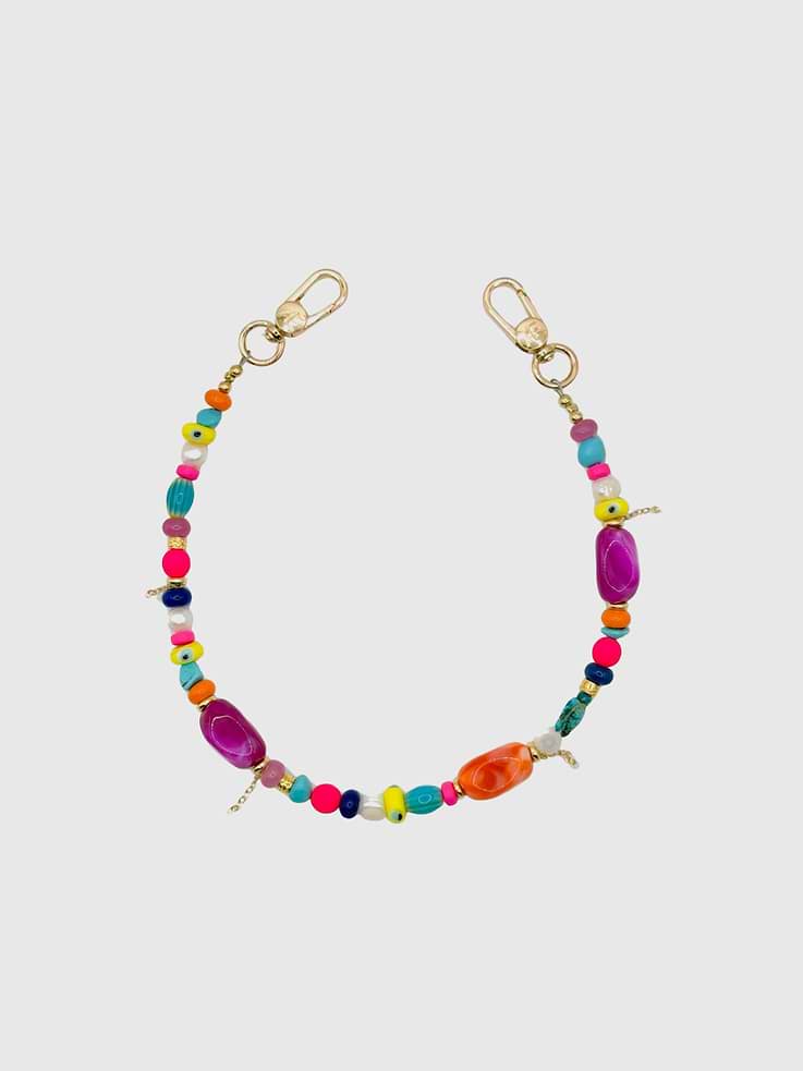 Image 1 of 1, Bold, playful, and impossible to ignore, the Cala Strap is a vibrant mix of acrylic statement beads, glass details, freshwater pearls, and evil eye accents finished with delicate 18k gold-plated mini chain accents for a subtle layered detail., Universal Phone Hitch required to attach to your phone case, sold separately., Over time, certain bead colors may lose their vibrancy due to exposure to air, water, and heat., Due to natural variations in gemstones and beads, product may differ slightly from displayed photos., THE CÆP in no way guarantees the integrity of your smartphone when using this strap.