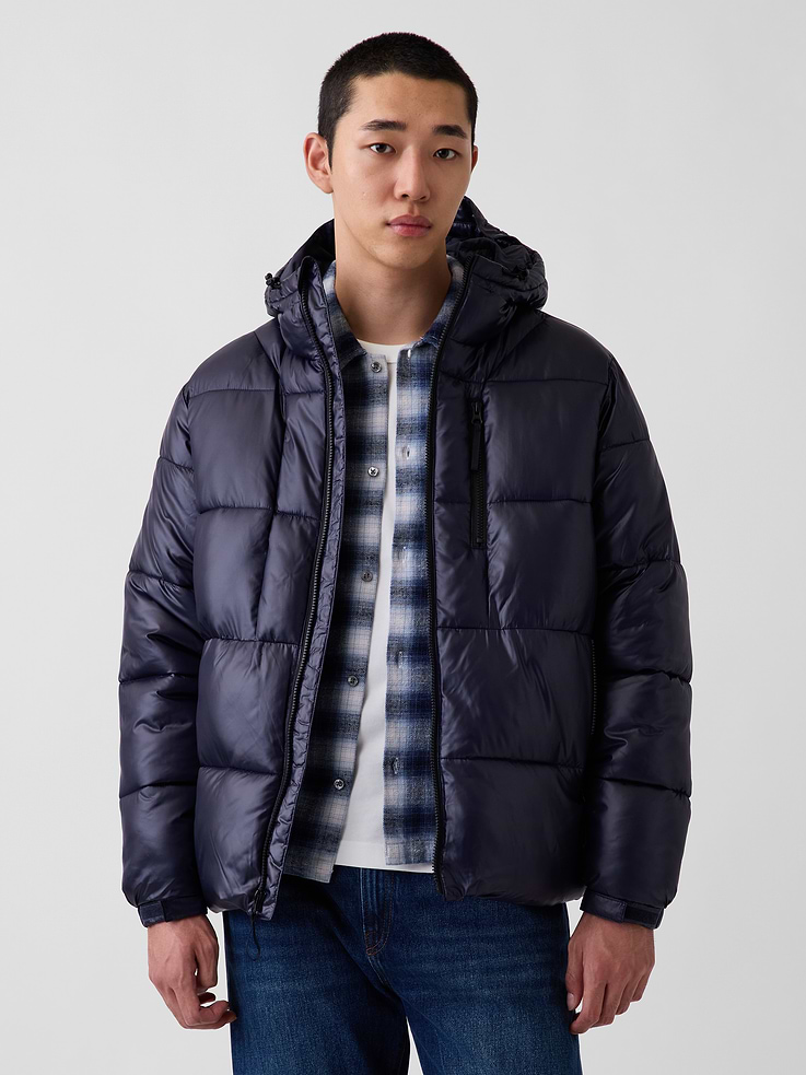 Image 1 of 6, Water-repellent, heavyweight ripstop puffer jacket. In an oversized fit., Hooded neckline with bungee cords at front hem., Long sleeves with elasticized cuffs and adjustable soft closures., Zipper front., Vertical zip pockets at front., Bungee hem., Made with 100% recycled polyester. Compared to virgin materials, using recycled materials helps reduce resource use and waste., Product #908461