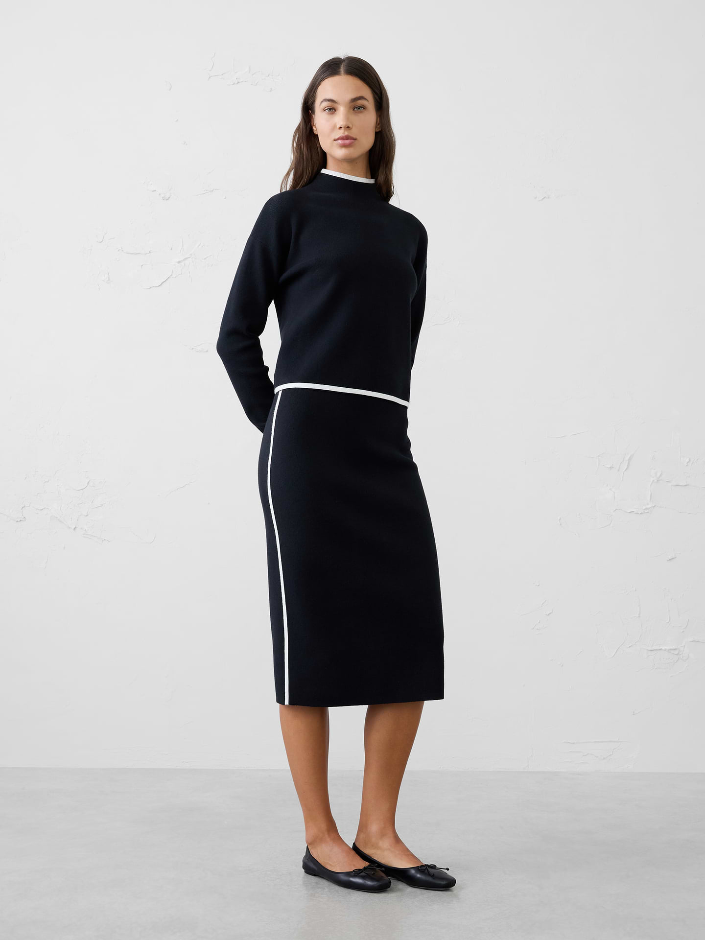 Image 1 of 4, Complete the look with this column midi sweater skirt, designed to pair perfectly with its matching sweater for an effortlessly polished outfit. Crafted from a soft knit fabric, this sleek skirt features a streamlined column silhouette that flatters the figure while offering comfortable stretch and ease of movement. Contrast piping along the sides adds a modern, sporty touch that enhances the clean design. Versatile enough to wear as a coordinated set or styled separately, this midi skirt transitions seamlessly from workdays to weekends., Pull on skirt., Contrast side piping adds a modern accent., Slim column silhouette creates a sleek, elongated look., Made exclusively for Banana Republic Factory., Product #1176482