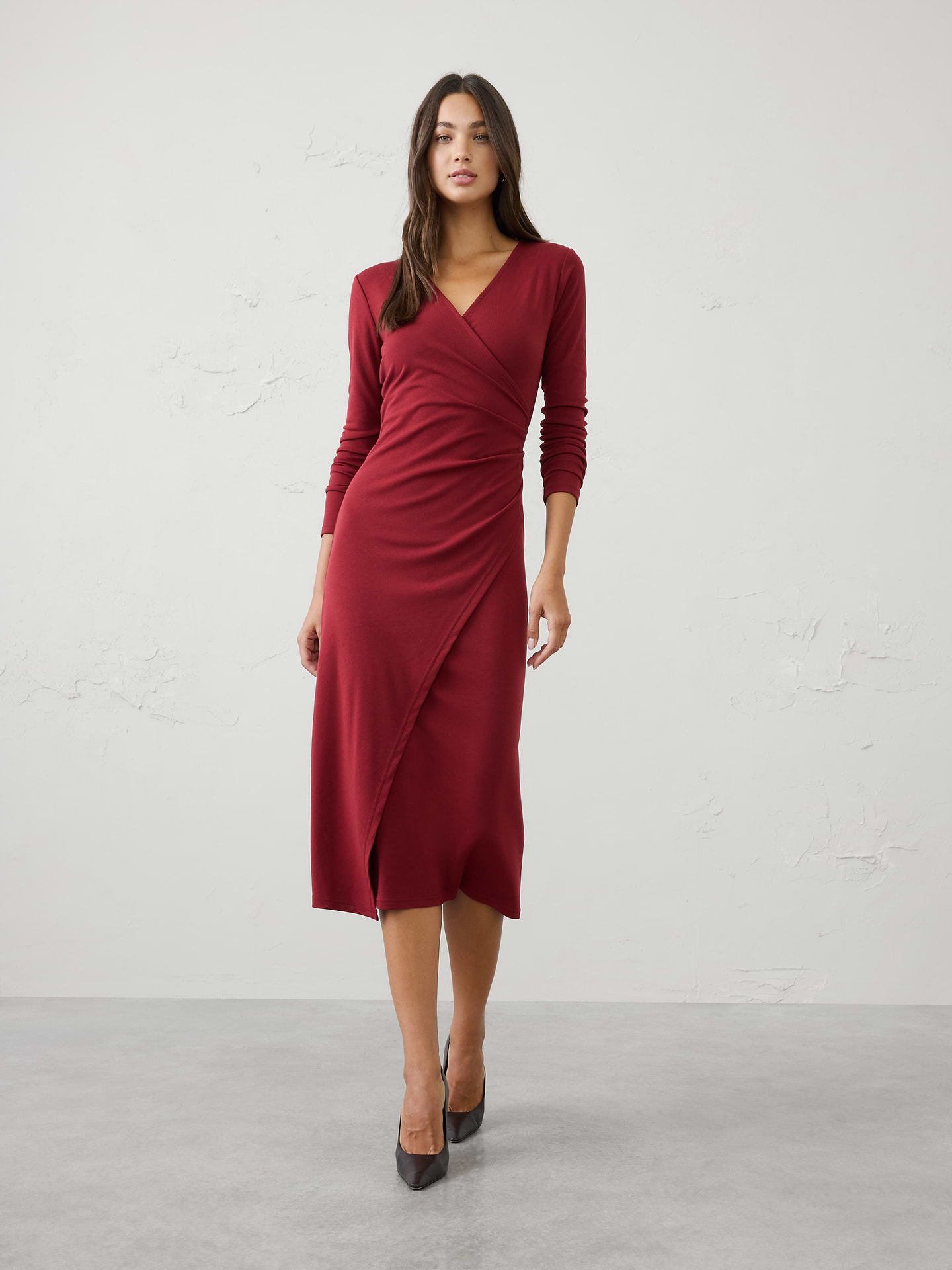 Image 1 of 3, Our customer‑favorite Cozy Rib fabric is reimagined in a flattering fixed‑wrap silhouette that effortlessly defines the waist. Soft, comfortable, and easy to wear, this long midi dress offers an elegant drape and polished look with the cozy feel you love., SUSTAINABILITY: Made with 60% recycled polyester., V-neckline. Long sleeves., Wrap‑inspired front panel., Side ruching gathers at the waist for flattering shape and dimension., Asymmetrical front overlay below the waist., Made exclusively for Banana Republic Factory., Product #1185679