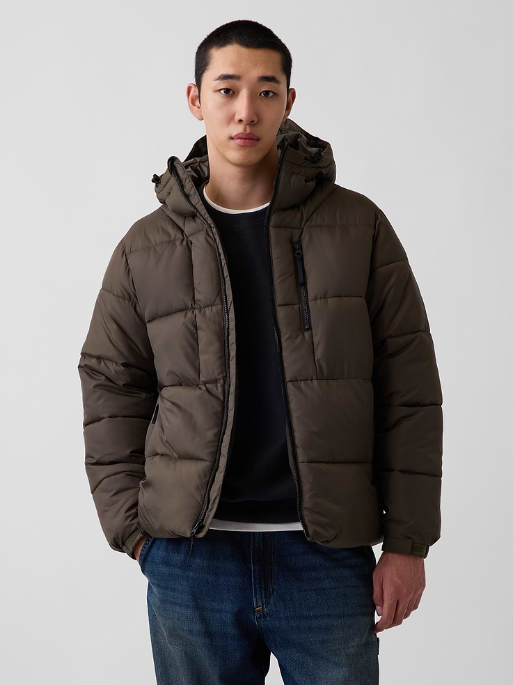 Image 1 of 6, Water-repellent, heavyweight ripstop puffer jacket. In an oversized fit., Hooded neckline with bungee cords at front hem., Long sleeves with elasticized cuffs and adjustable soft closures., Zipper front., Vertical zip pockets at front., Bungee hem., Made with 100% recycled polyester. Compared to virgin materials, using recycled materials helps reduce resource use and waste., Product #908461