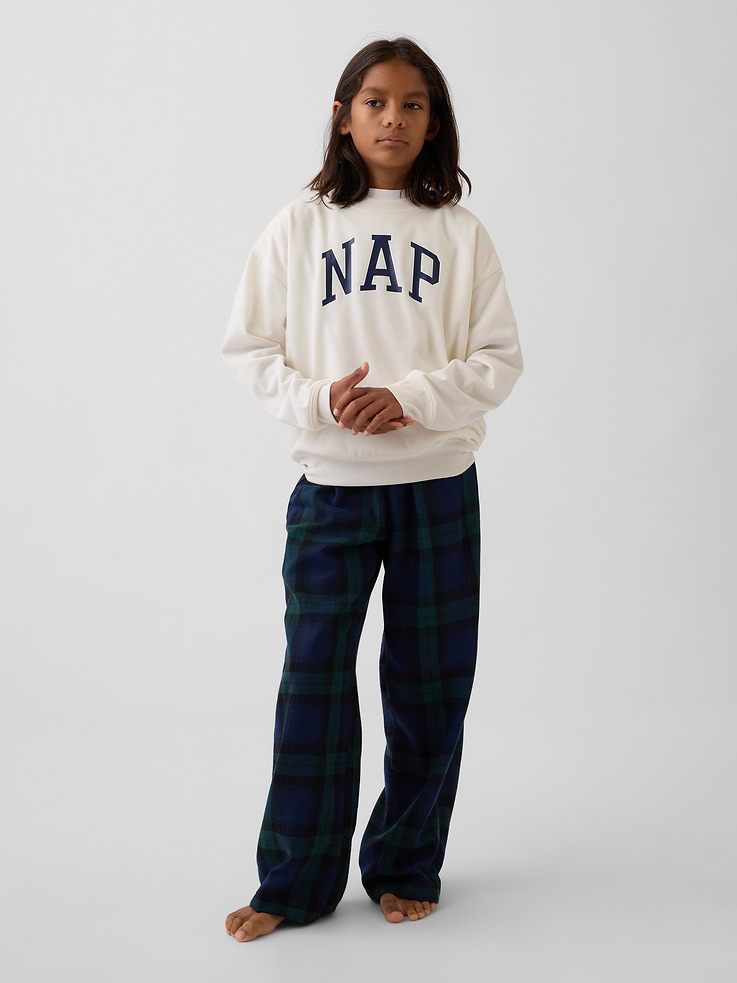 Image 1 of 5, Soft knit pajama sweatshirt. In a relaxed fit., Crewneck., Long sleeves with drop shoulders., NAP logo at front., Banded cuffs and hem., Made with 100% recycled polyester. Compared to virgin materials, using recycled materials helps reduce resource use and waste., This product was made in a factory that invests in gender equity and women’s empowerment through RISE. Learn more at gapinc.com/equity ., Product #908982