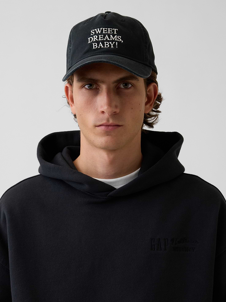 Image 1 of 5, Sturdy cotton baseball hat., Stitching at curved brim., Roy Litchenstein's Sweet Dreams, Baby! inspired embroidered detailing., This product was made in a factory that invests in gender equity and women’s empowerment through RISE. Learn more at gapinc.com/equity ., Product #1189426