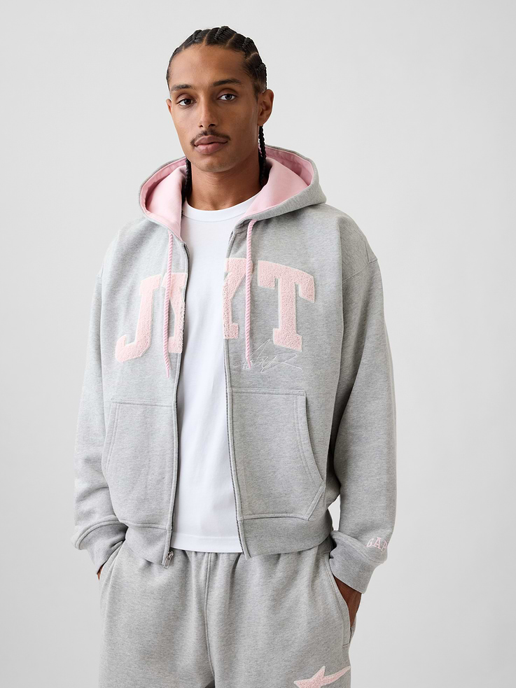 Image 1 of 10, Soft, heavyweight fleece hoodie. In an oversized fit., Hooded neckline with drawcords., Long sleeves with dropped shoulders., Zipper closure., Kanga pockets., JYT arch logo and graphics., Banded hem and cuffs., Made with 14% recycled polyester. Compared to virgin materials, using recycled materials helps reduce resource use and waste., Product #1196140