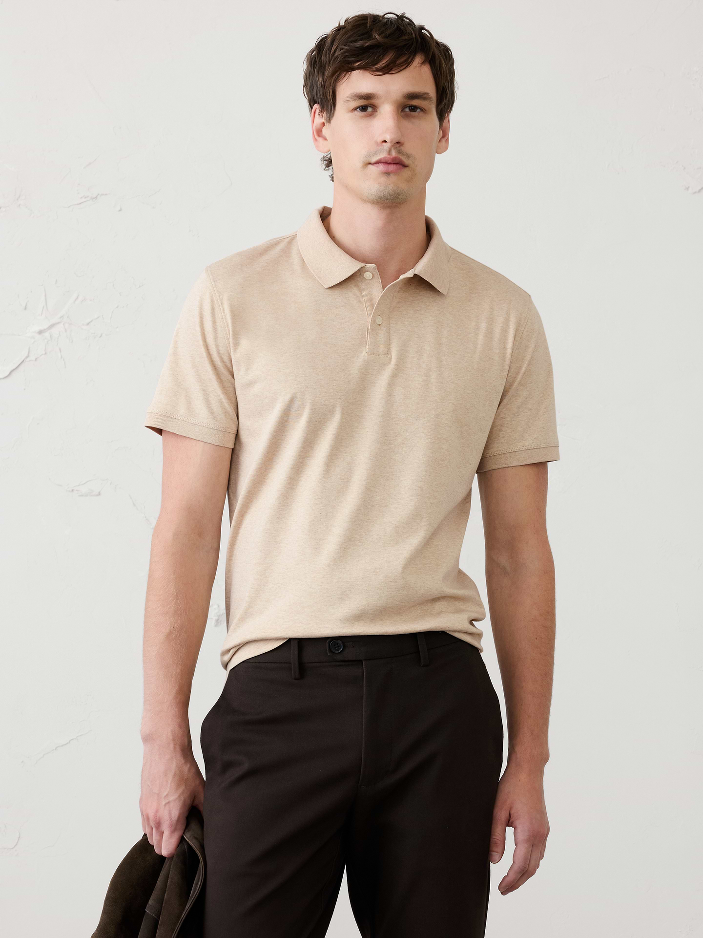 Image 1 of 8, Made with 100% cotton interlock, which is extremely soft, firm, and absorbent. Mercerization treatment gives this fabric a silk-like lustrous appearance for a polished look and hand feel, adding strength and reducing shrinkage., Polo collar with button placket. Short sleeves., Straight hem with side vents., Made exclusively for Banana Republic Factory., Product #667172