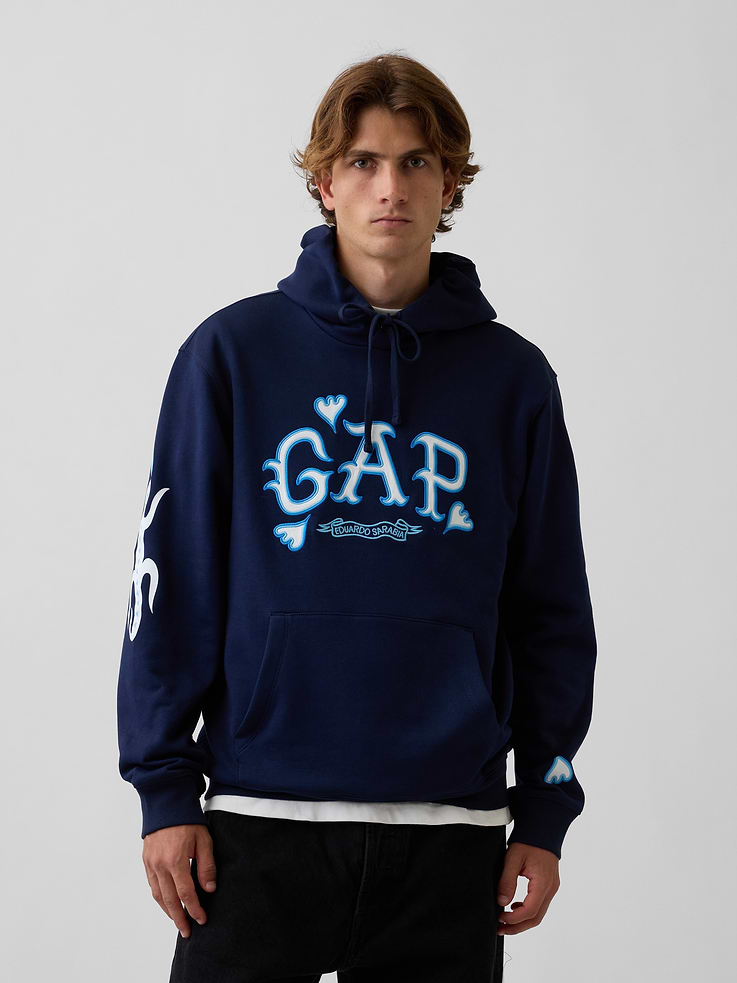 Image 1 of 8, In celebration of Gap Hoodie Day, we brought together emerging designers from all over the world. Reimagining our iconic logo hoodie. Making it new again., Soft, heavyweight cotton-blend fleece hoodie. In a relaxed fit., Hooded neckline with drawcords., Long sleeves., Kanga pocket., Banded hem and cuffs., Gap arch logo, redesigned by Eduardo Sarabia., Product #1199913