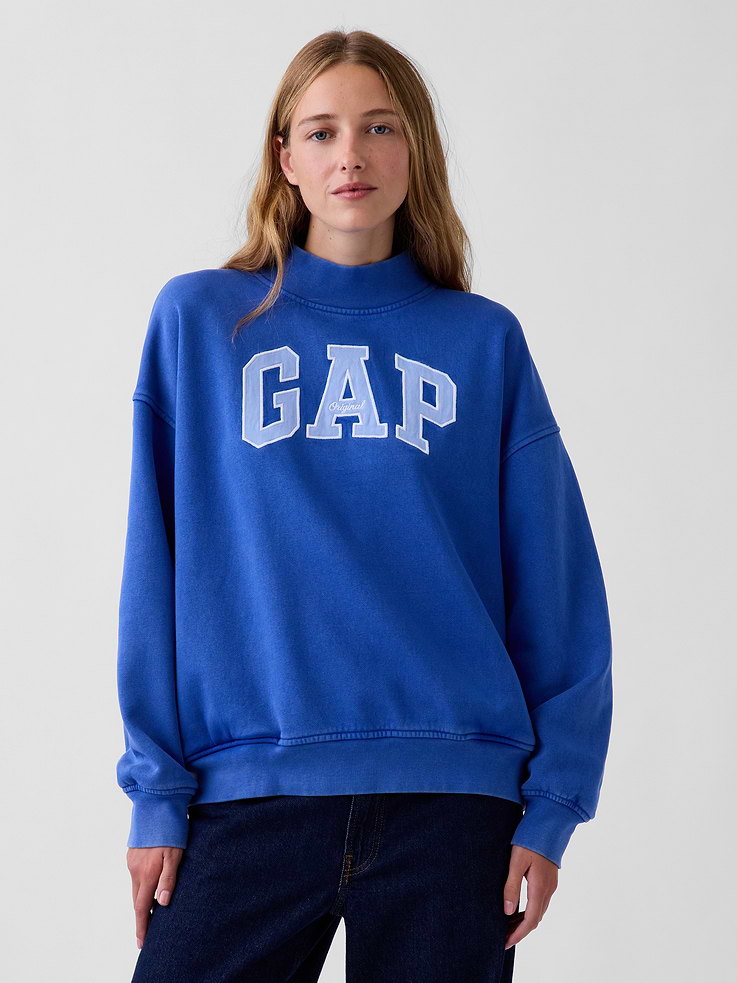 Image 1 of 7, Soft cotton-blend fleece pullover sweatshirt. In an oversized fit and tunic length., Mockneck., Long sleeves with drop shoulders., Gap arch logo at front., Banded rib cuffs and hem., Made with 52% Protocol cotton verified by the U.S. Cotton Trust Protocol, a program which works with farms committed to improving their environmental footprint by minimizing water usage and improving soil health (Claim No. 10127)., Made with 23% recycled polyester. Compared to virgin materials, using recycled materials helps reduce resource use and waste., Product #908994