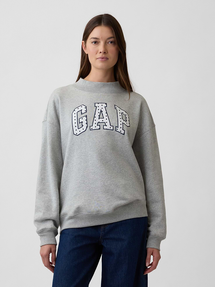 Image 1 of 5, This style is made with 23% recycled polyester. Compared to virgin materials, using recycled materials helps to reduce resource use and waste., Soft, comfy fleece., Dropped shoulder, long sleeves with banded cuffs., Mockneck., Gap logo at front., Banded hem., Product #1174684