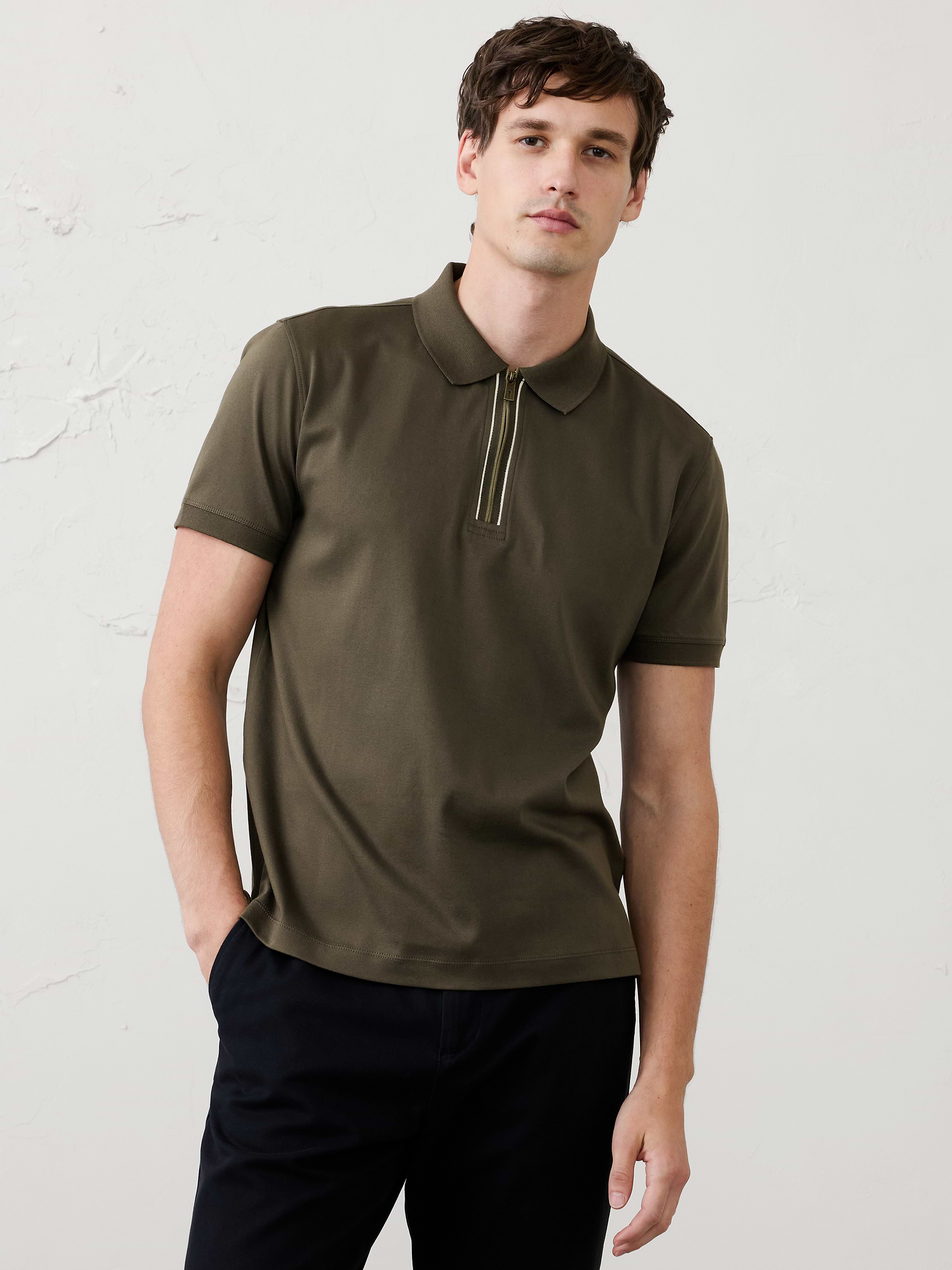 Image 1 of 6, Made with 100% cotton interlock, which is extremely soft, firm, and absorbent. Mercerization treatment gives this fabric a silk-like lustrous appearance for a polished look and hand feel, adding strength and reducing shrinkage., Polo collar with zipper placket. Short sleeves., Straight hem with side vents., Made exclusively for Banana Republic Factory., Product #1176089