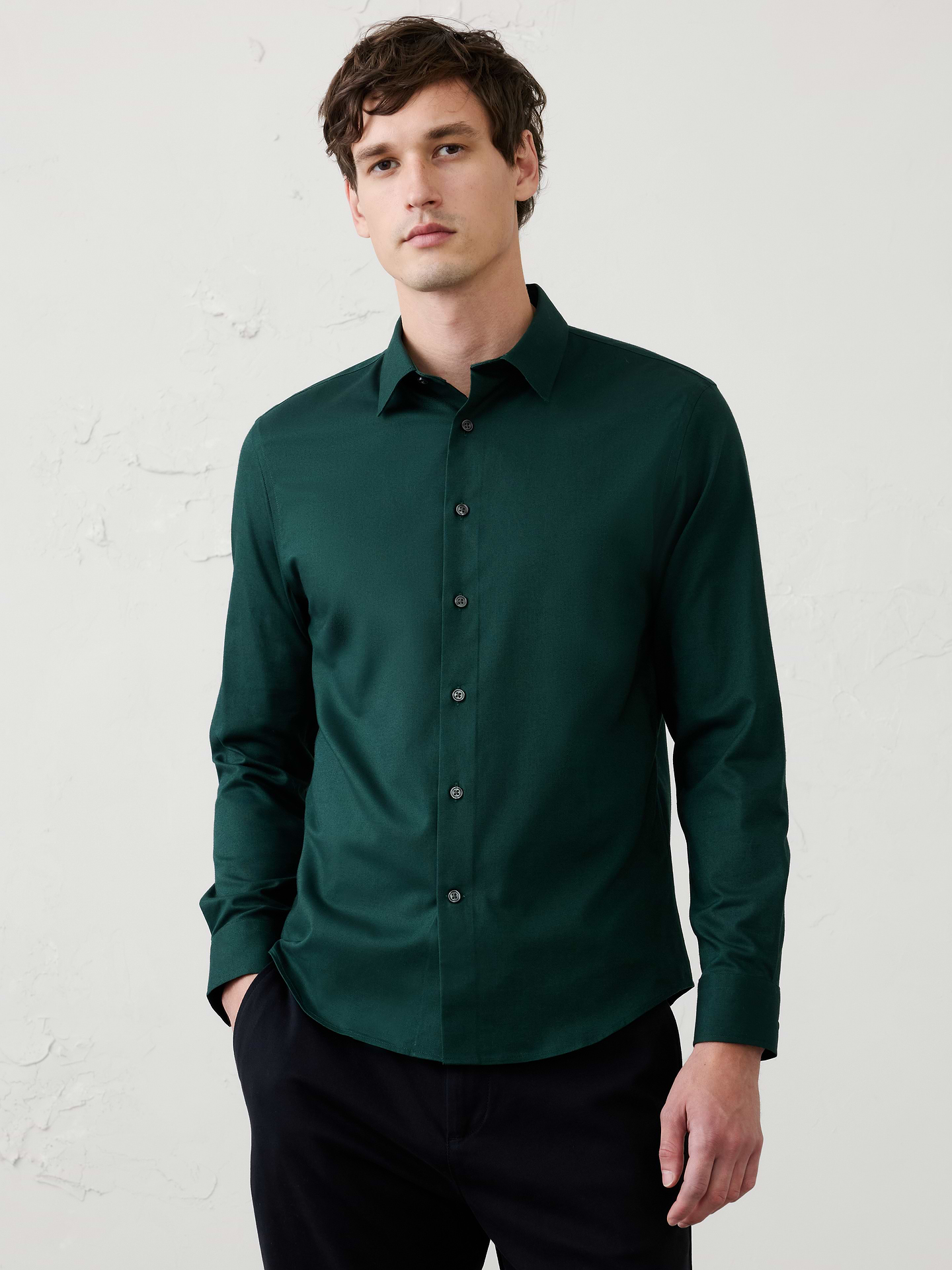 Image 1 of 8, WRINKLE RESISTANT: No need to iron, these soft, cotton dress shirts are specially engineered to resist wrinkles so it stays looking crisp and pulled-together., UNTUCKED: Designed with a shorter hemline to hit right at the hips., Spread collar. Long sleeves with adjustable double-button barrel cuffs and button vents., Clean front., Shirttail hem., Made exclusively for Banana Republic Factory., Product #1175947